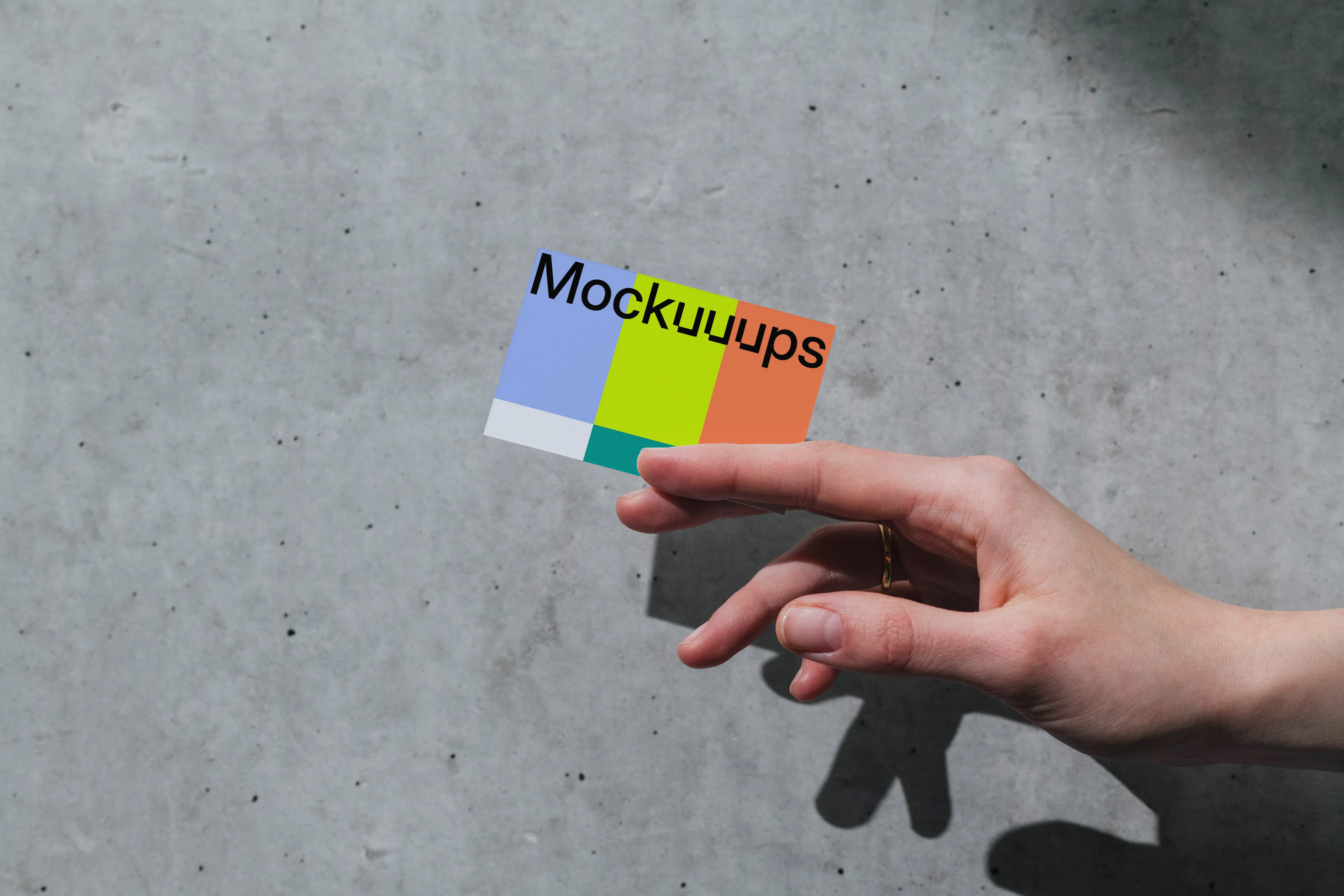 Business card mockup with hand on concrete background