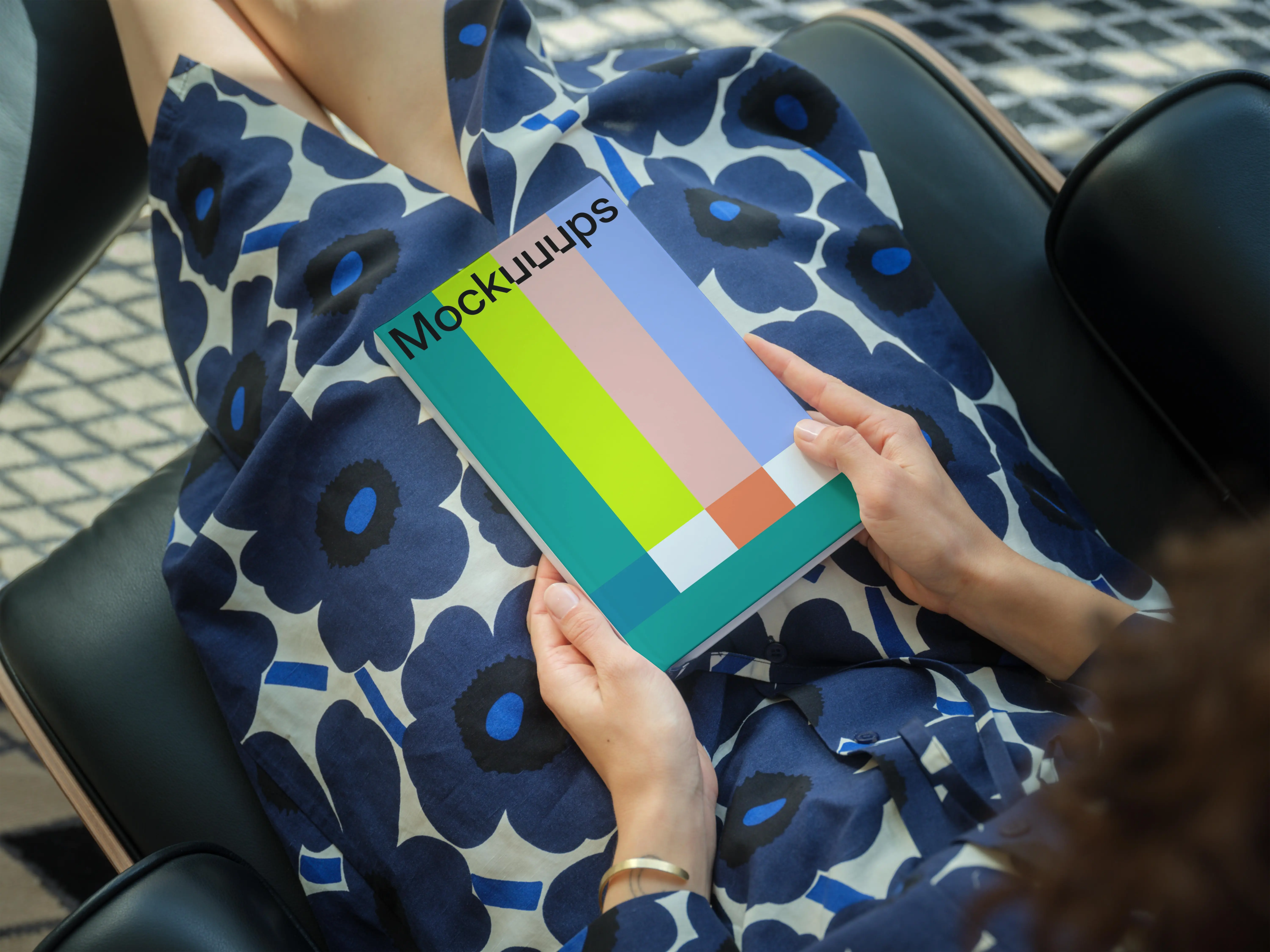 C-format book mockup held by a seated person