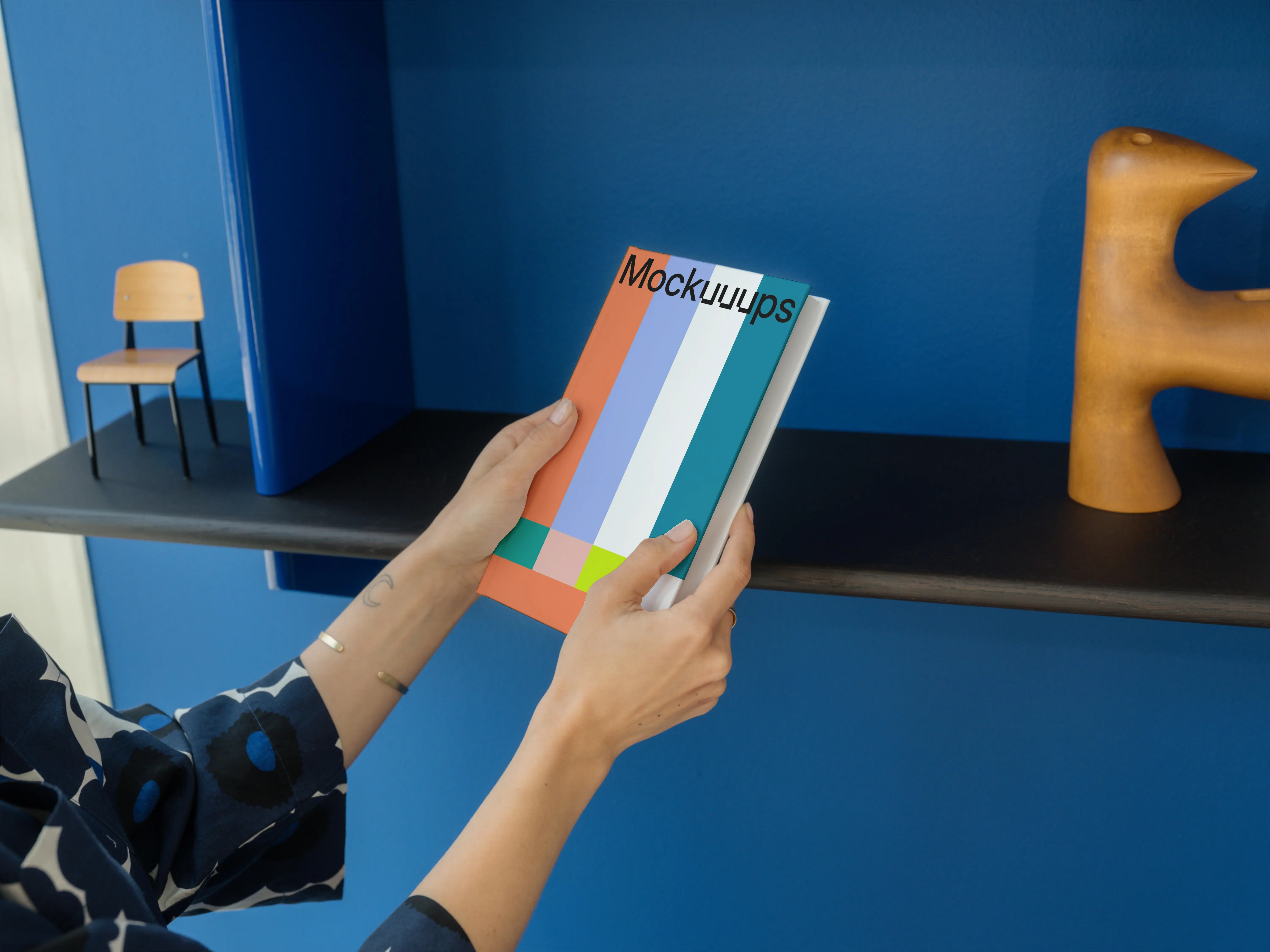 C-format book mockup held in a modern interior