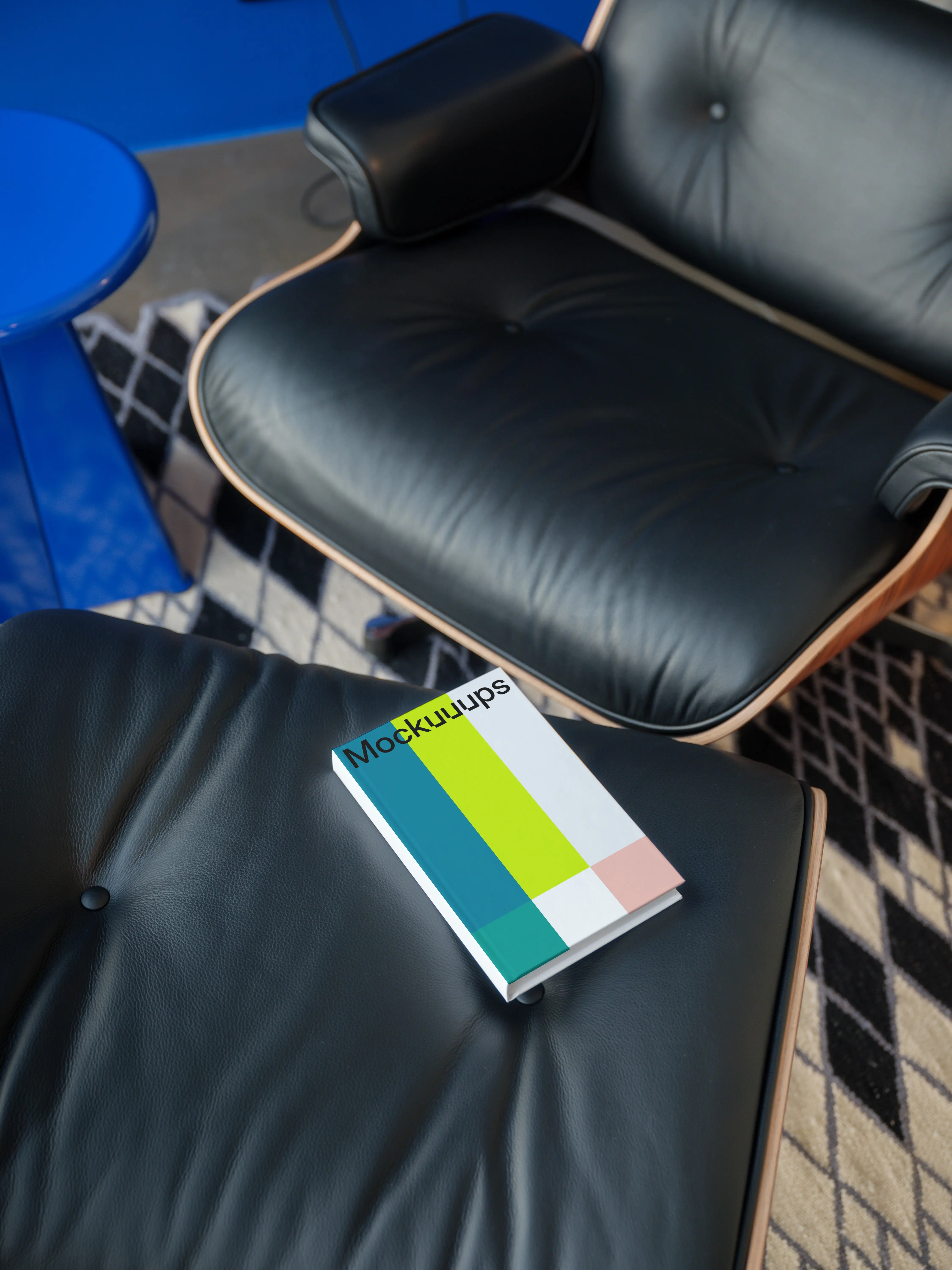 C-format book mockup on a leather chair in a modern setting