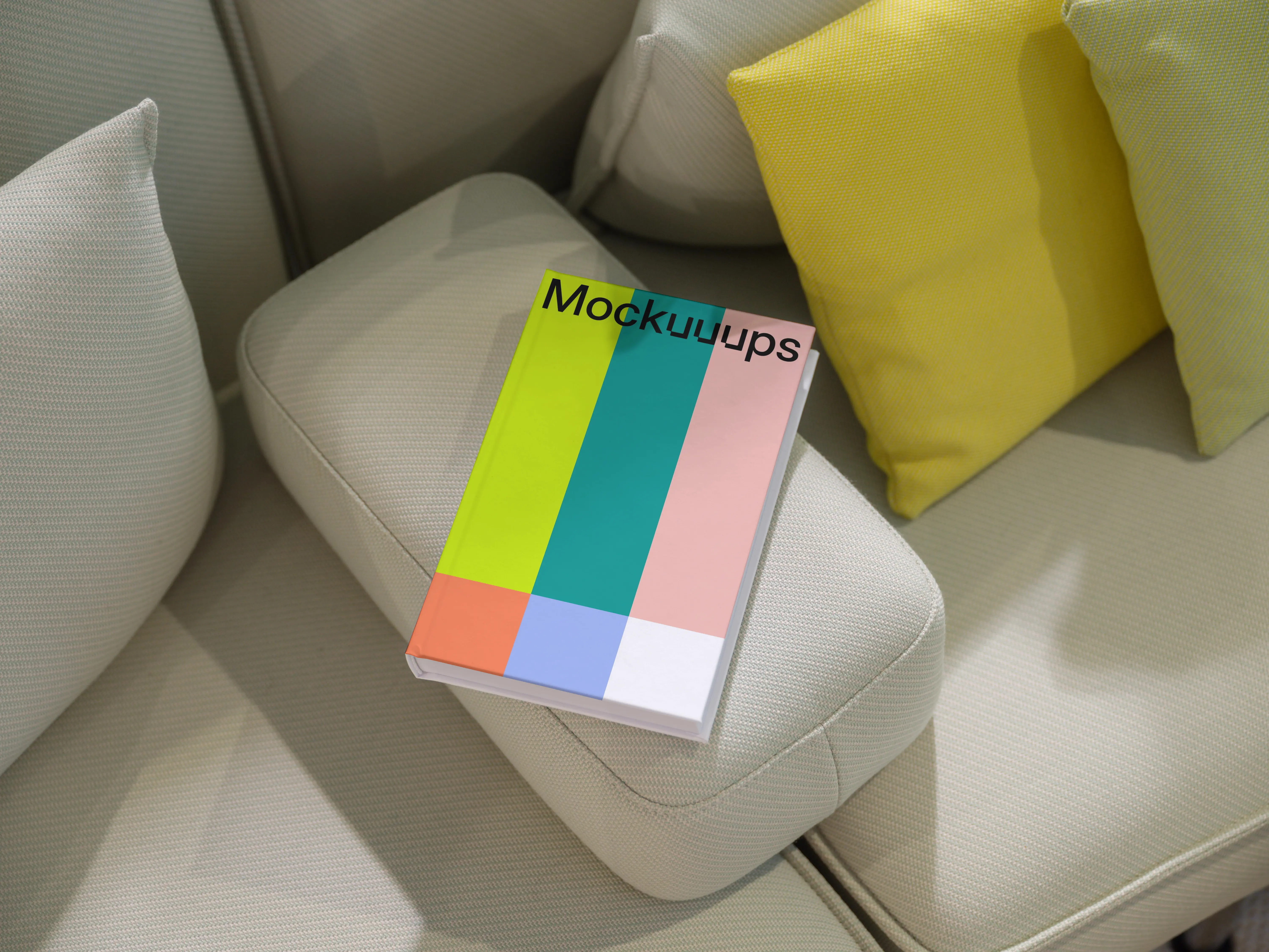 C-format book mockup on a modern sofa with cushions