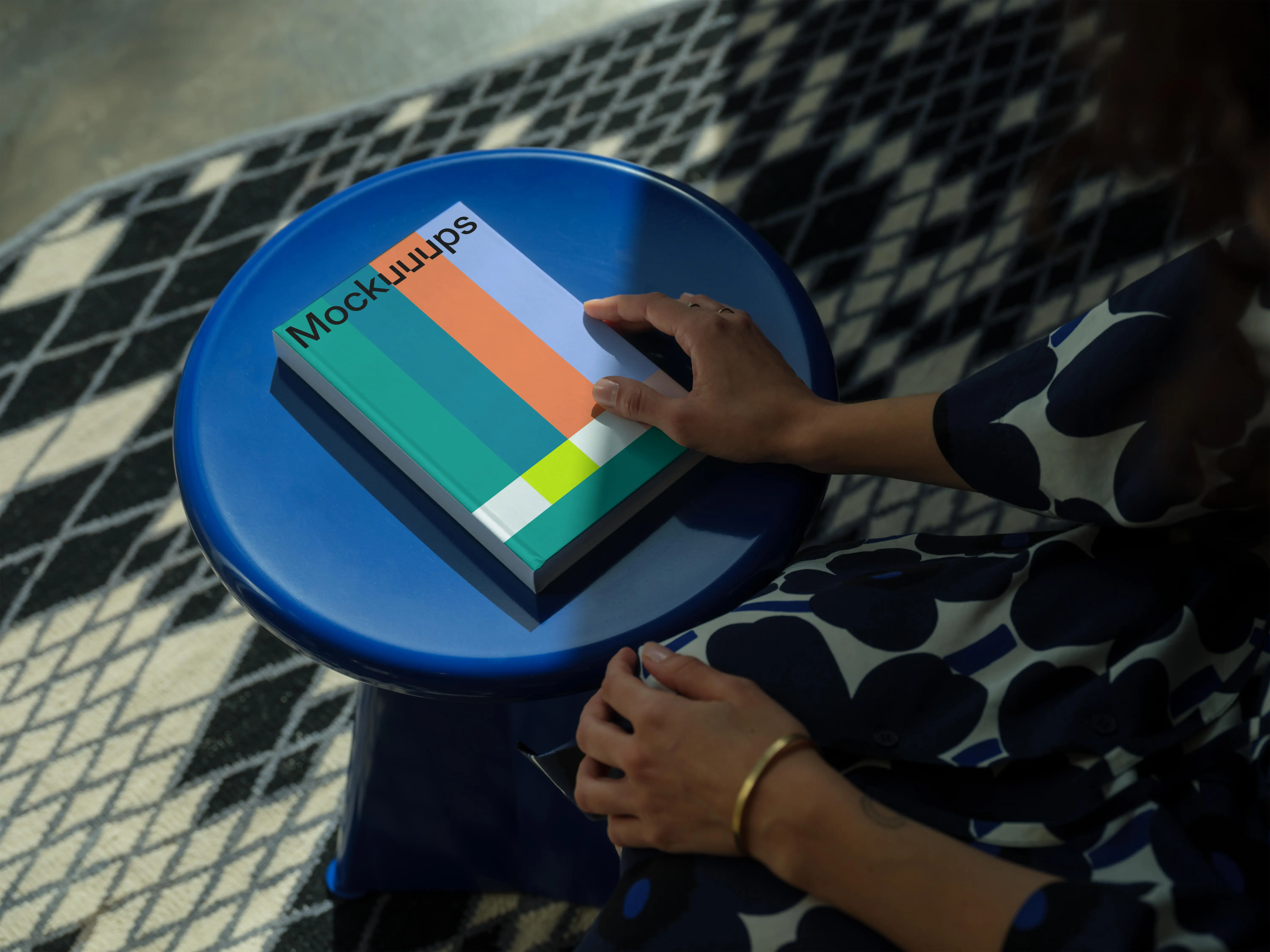 C-format book mockup on a round blue stool