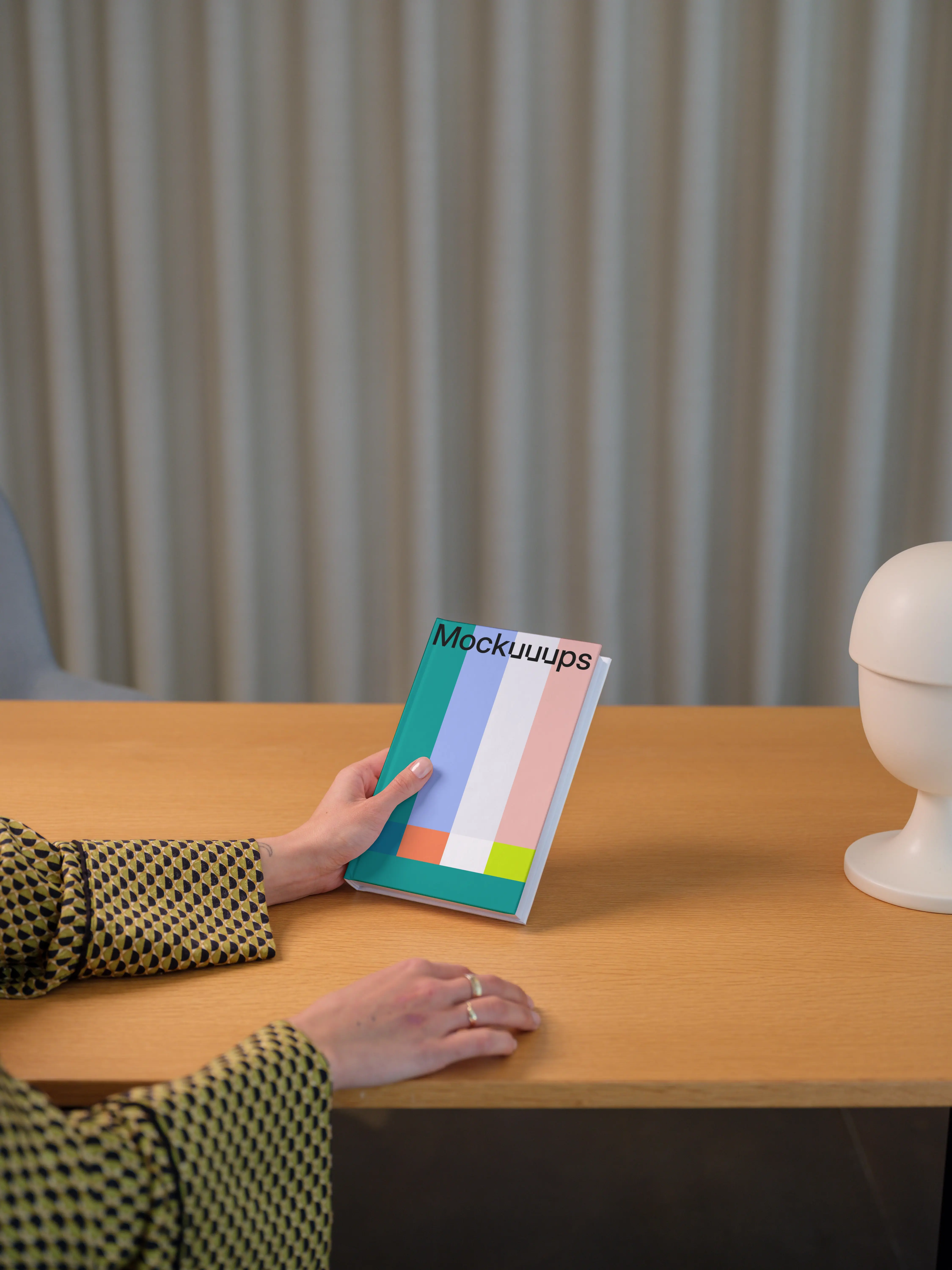 C-format book mockup on a wooden desk