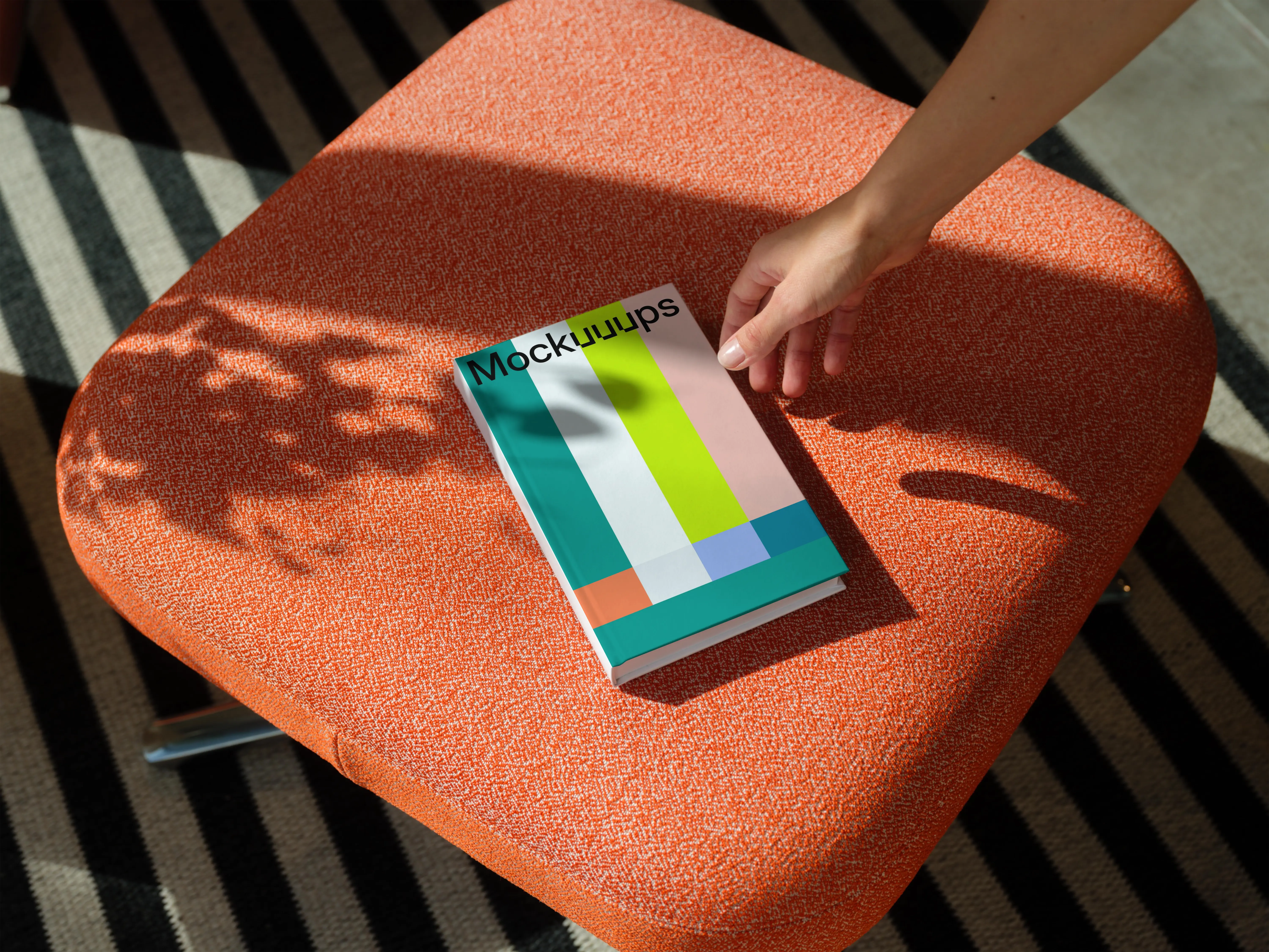 C-format book mockup on an orange fabric chair