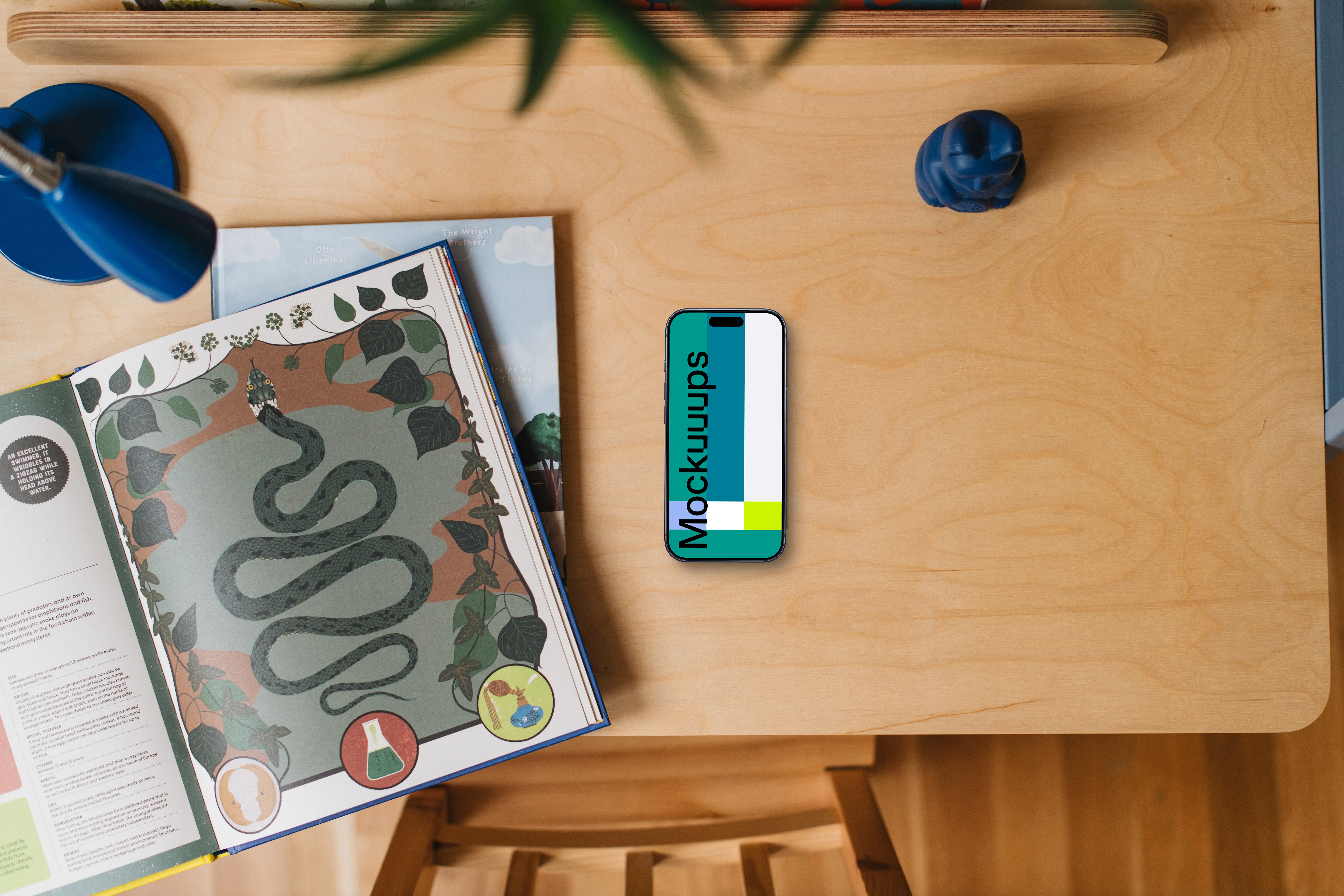 Children's book and smartphone mockup on wooden table