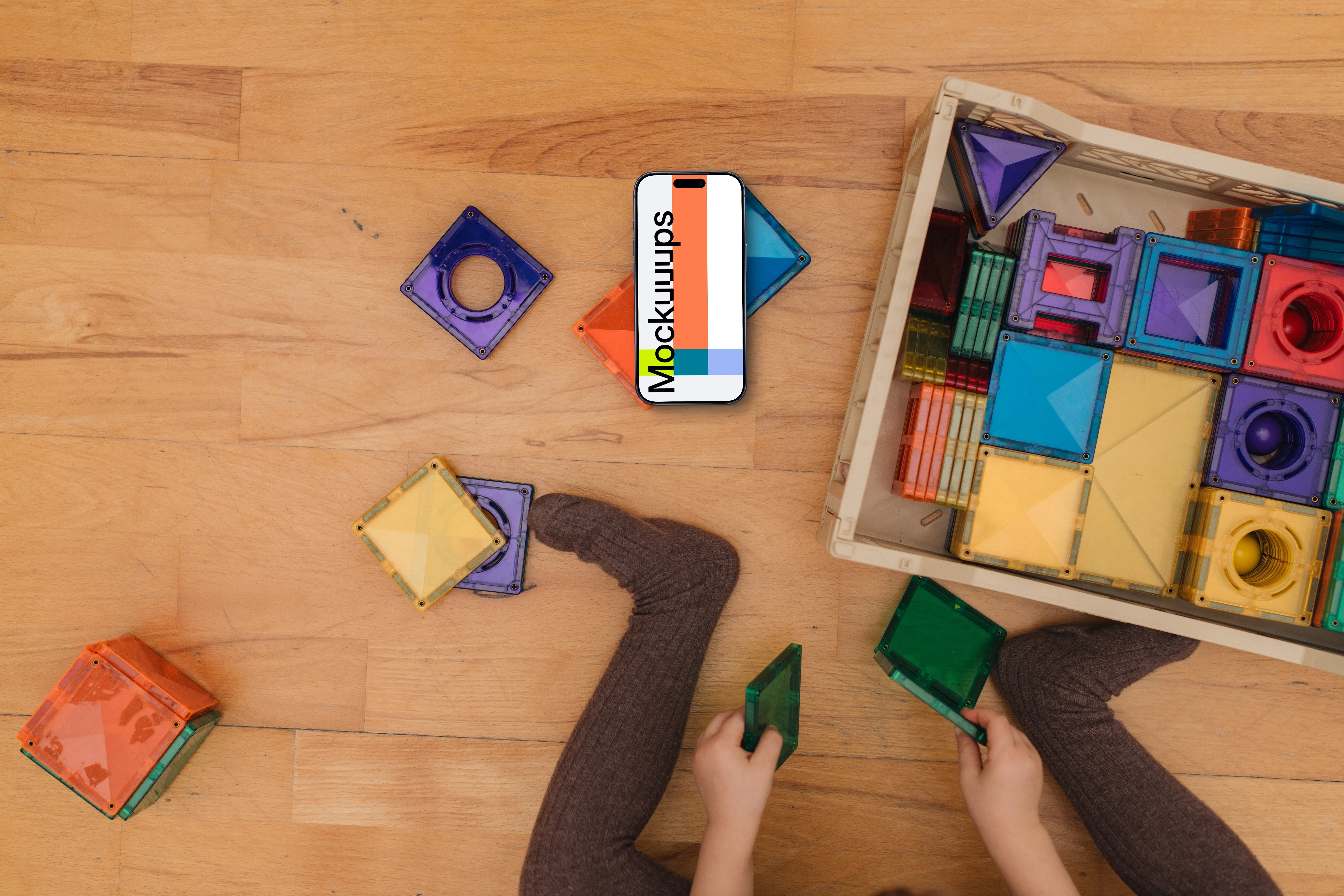 Children's play area mockup with smartphone and colorful toys