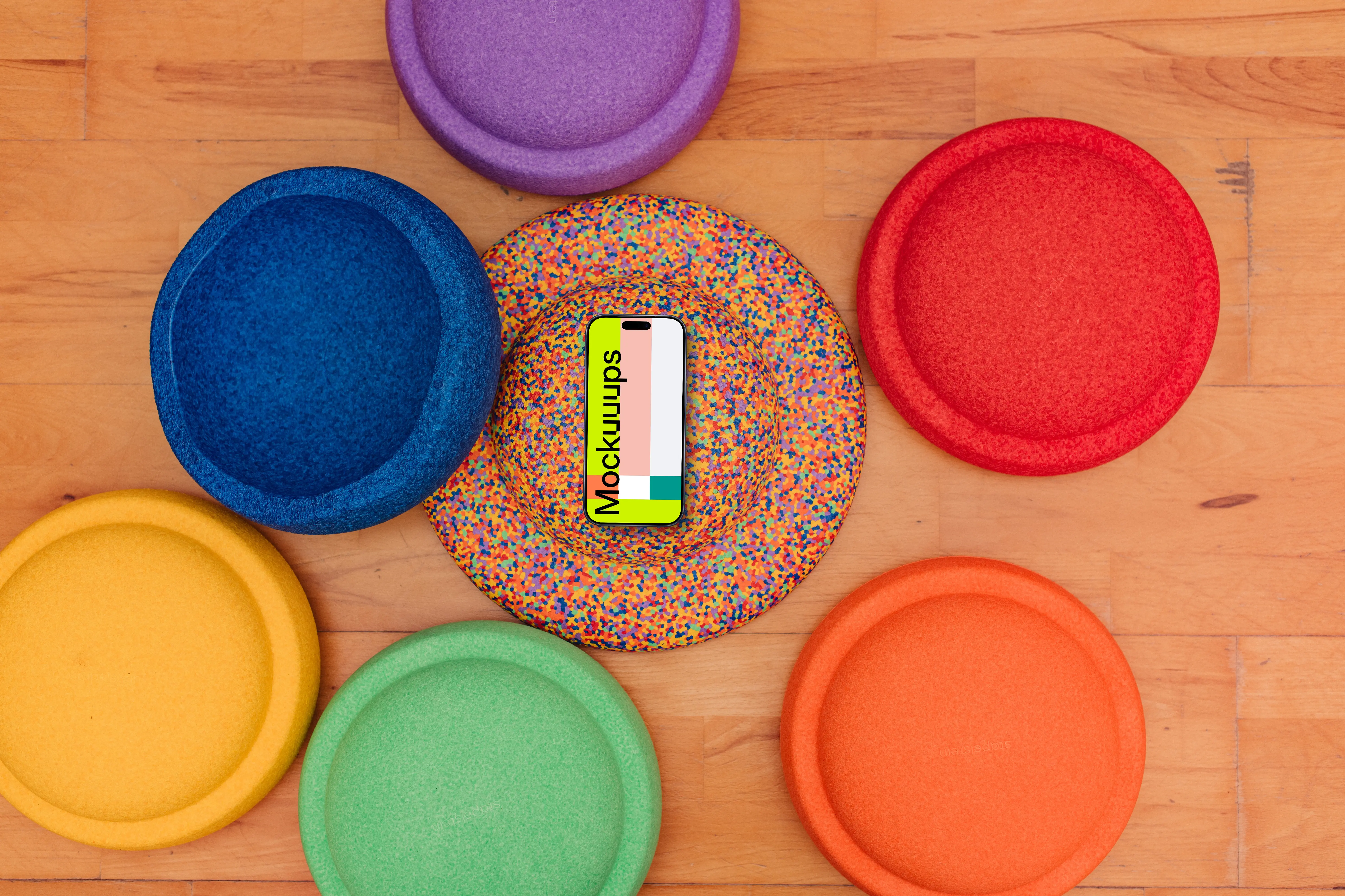 Colorful foam circles and smartphone mockup on wooden floor