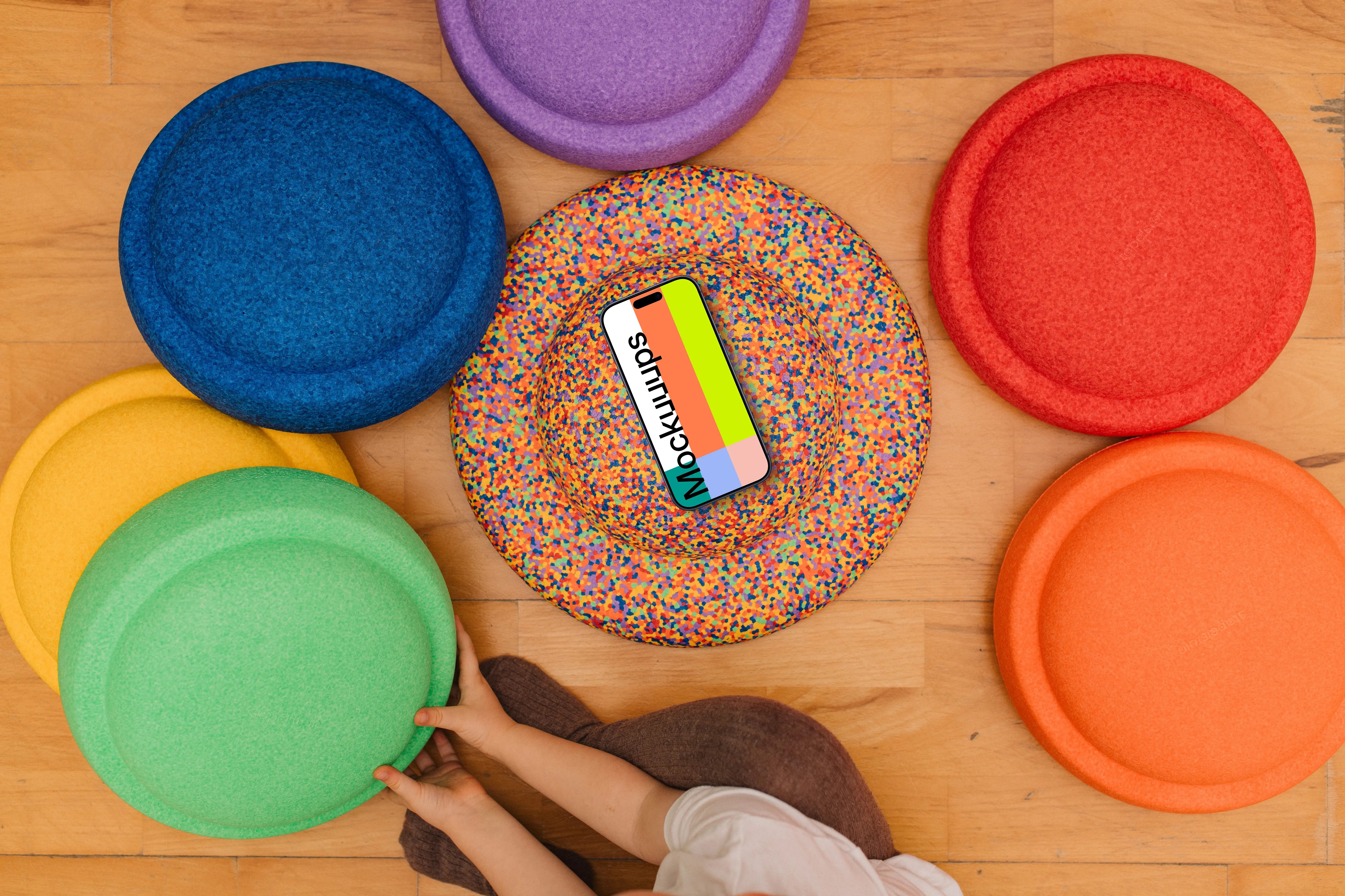 Colorful play mats mockup with smartphone and child interaction