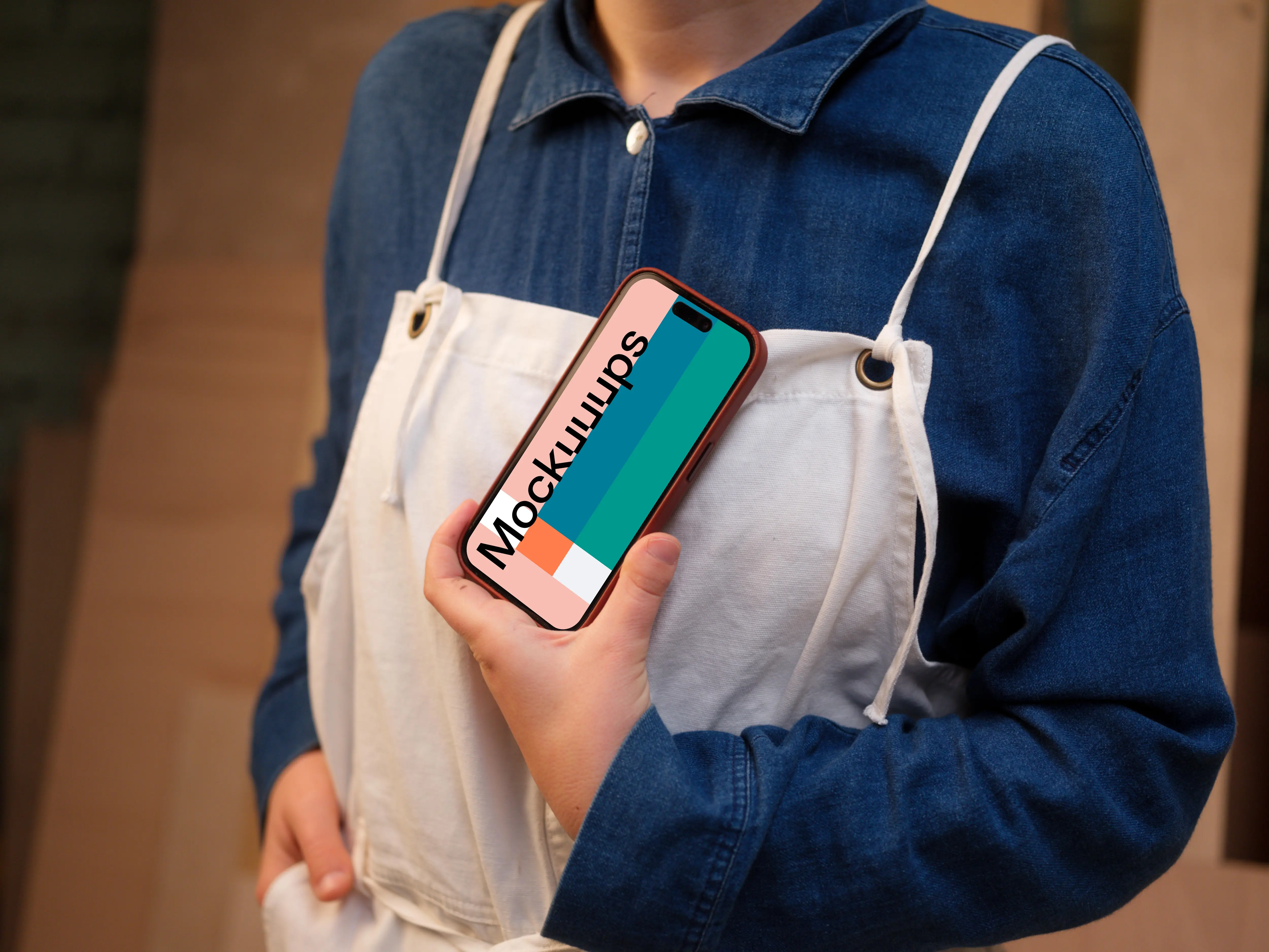Crafter holding an iPhone mockup in the workshop