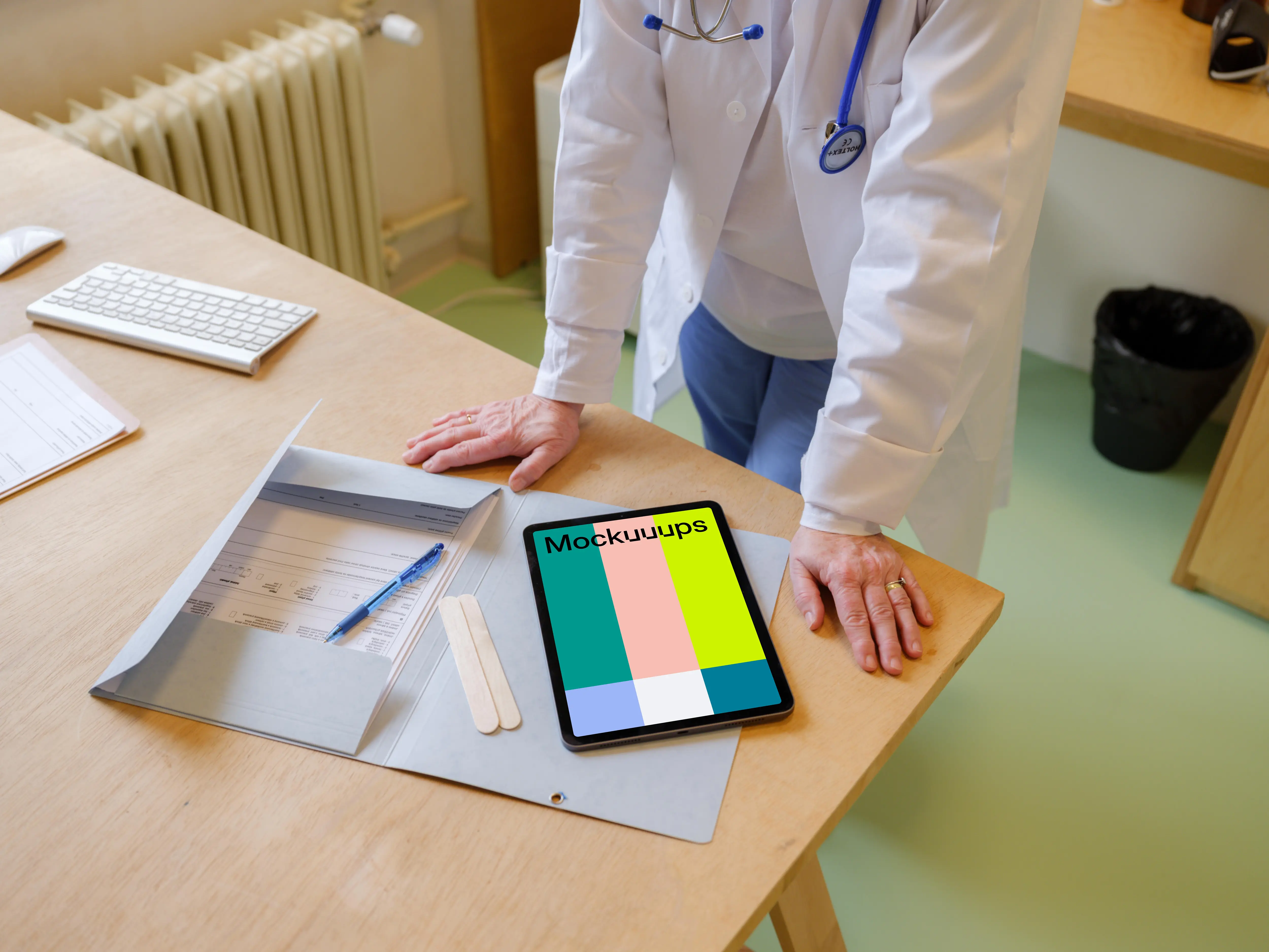 Doctor standing next to the iPad mockup