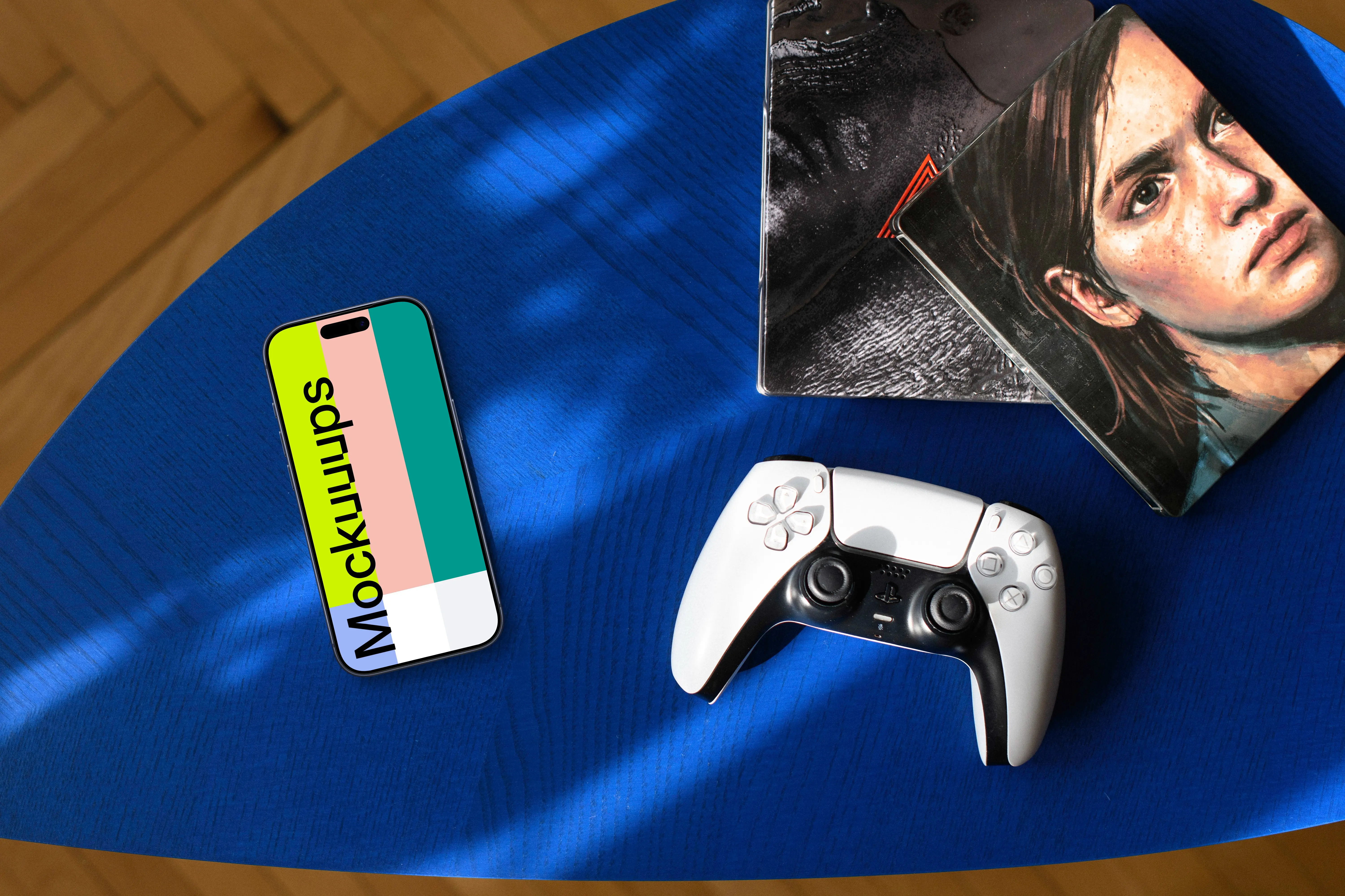 Gaming smartphone mockup with controller and artwork on blue table