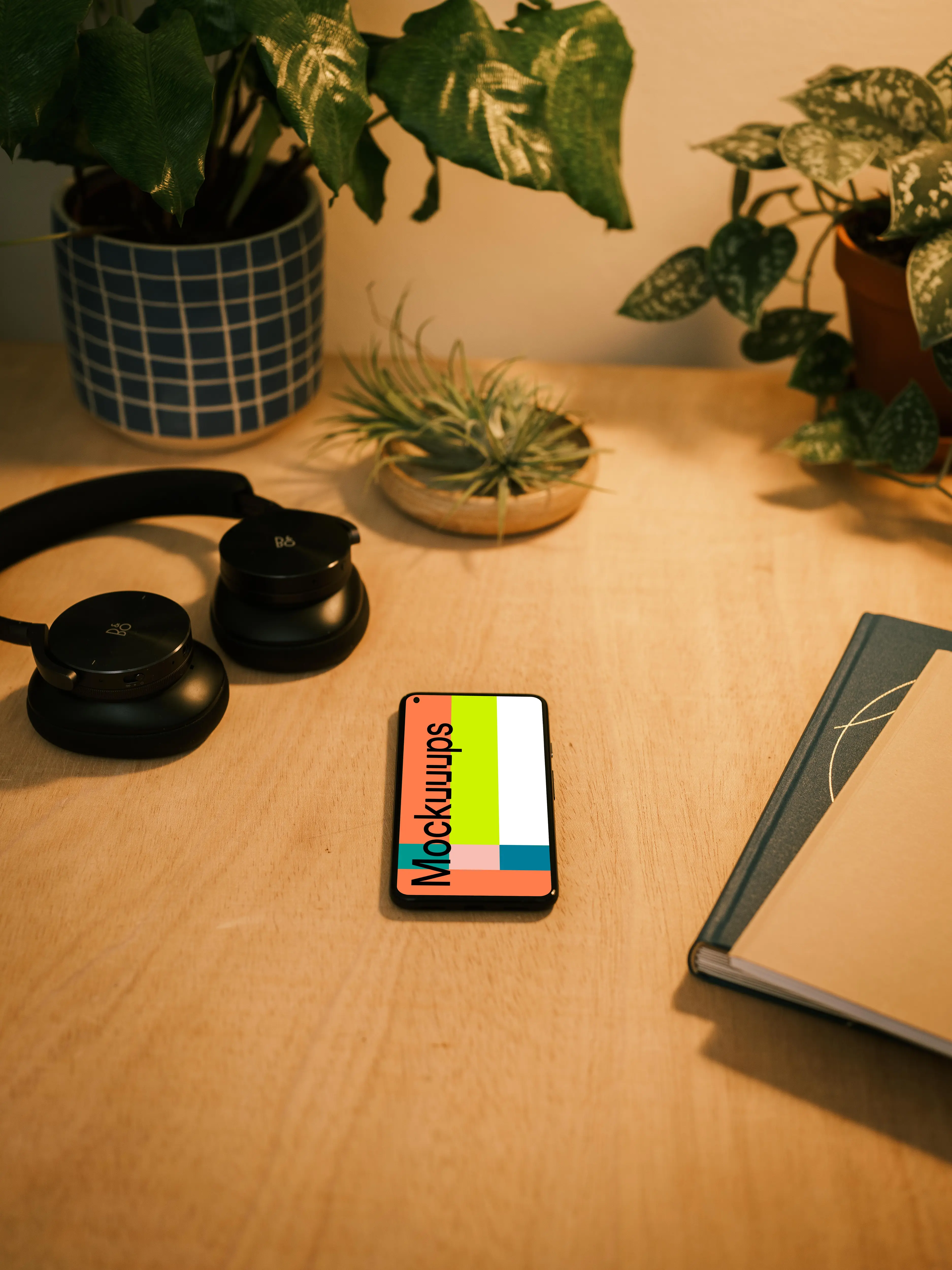 Google Pixel 5 mockup with a pair of headphones at the side