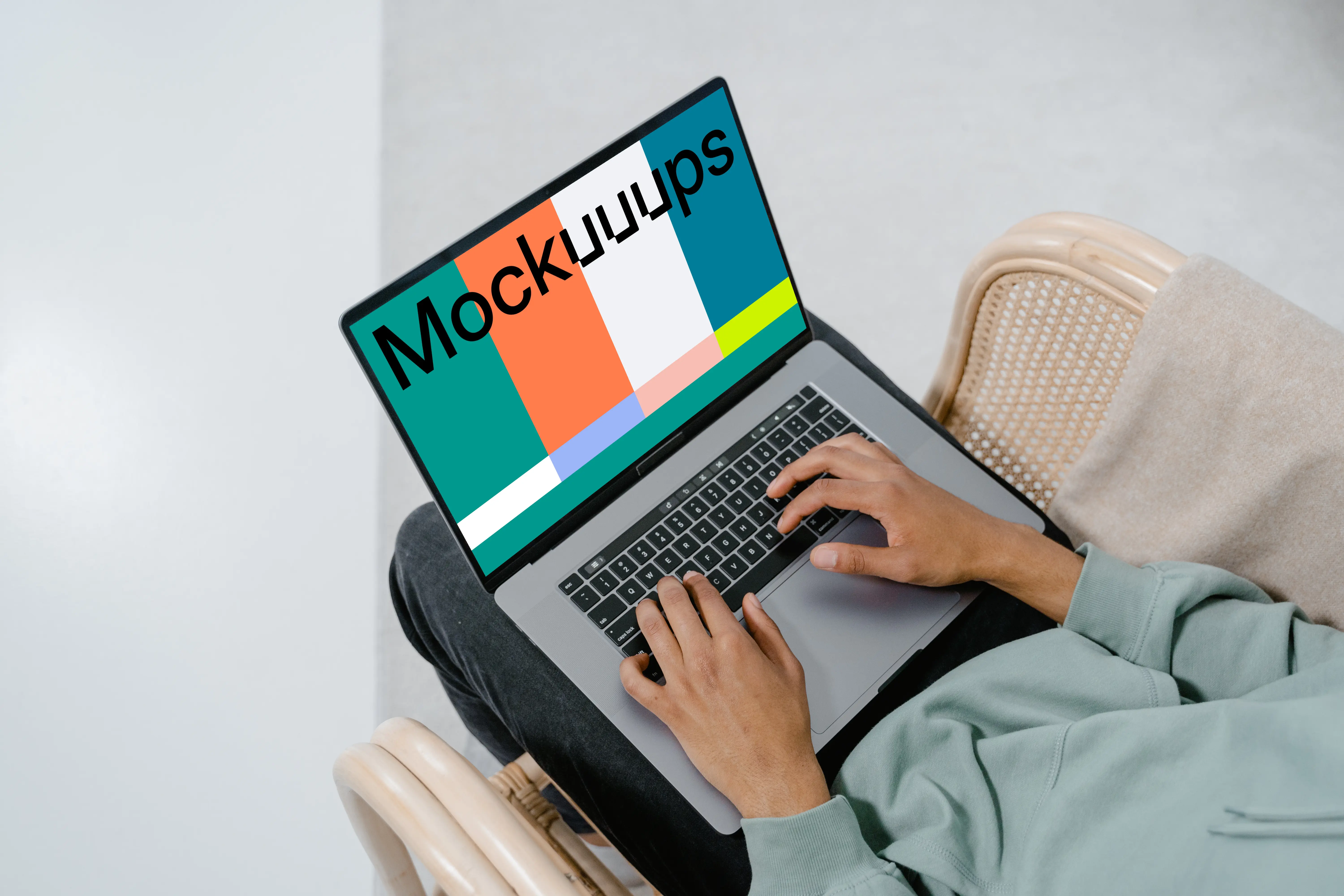 Grey MacBook mockup on user’s laps