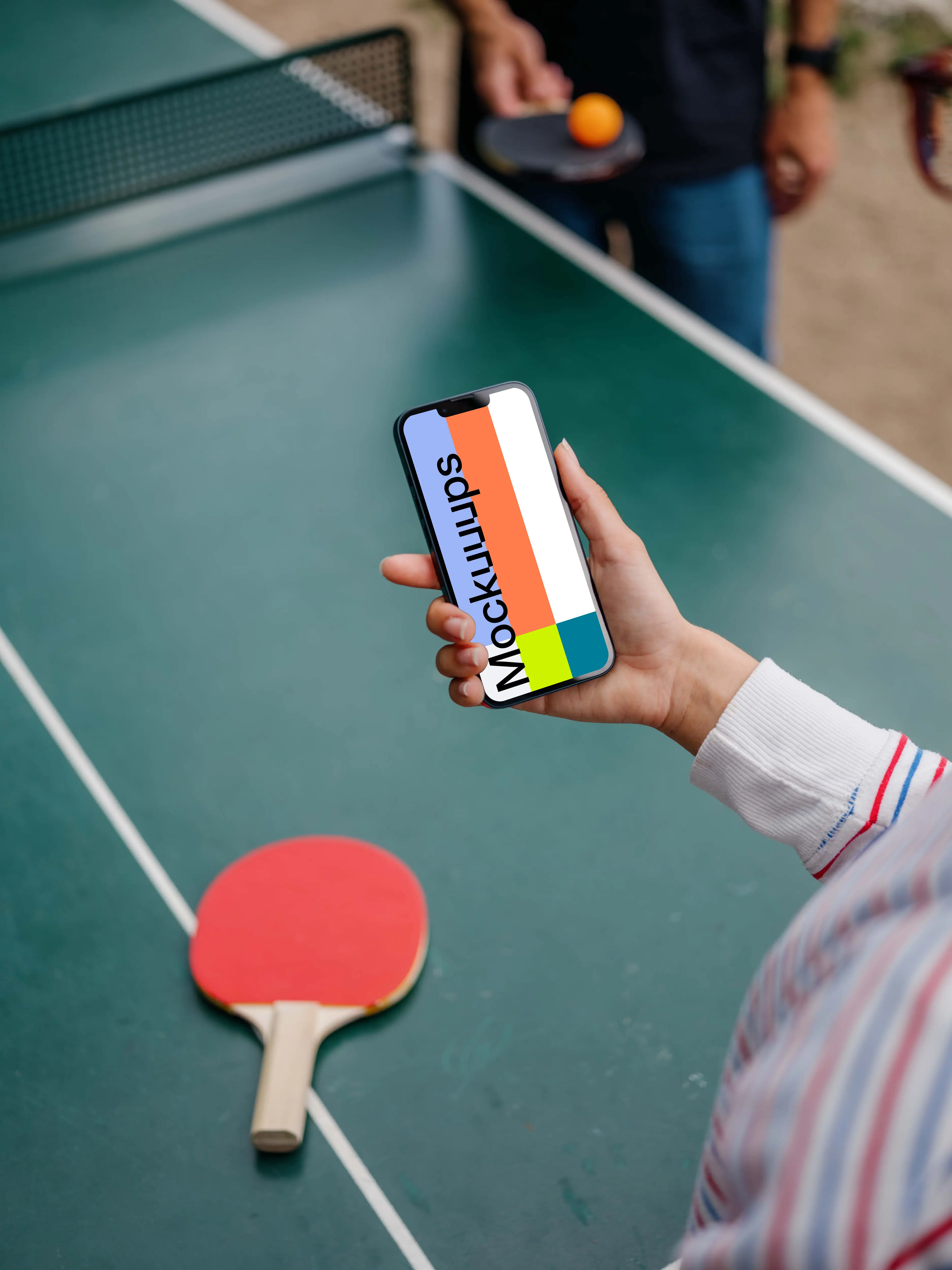 Hand holding an iPhone 13 mockup