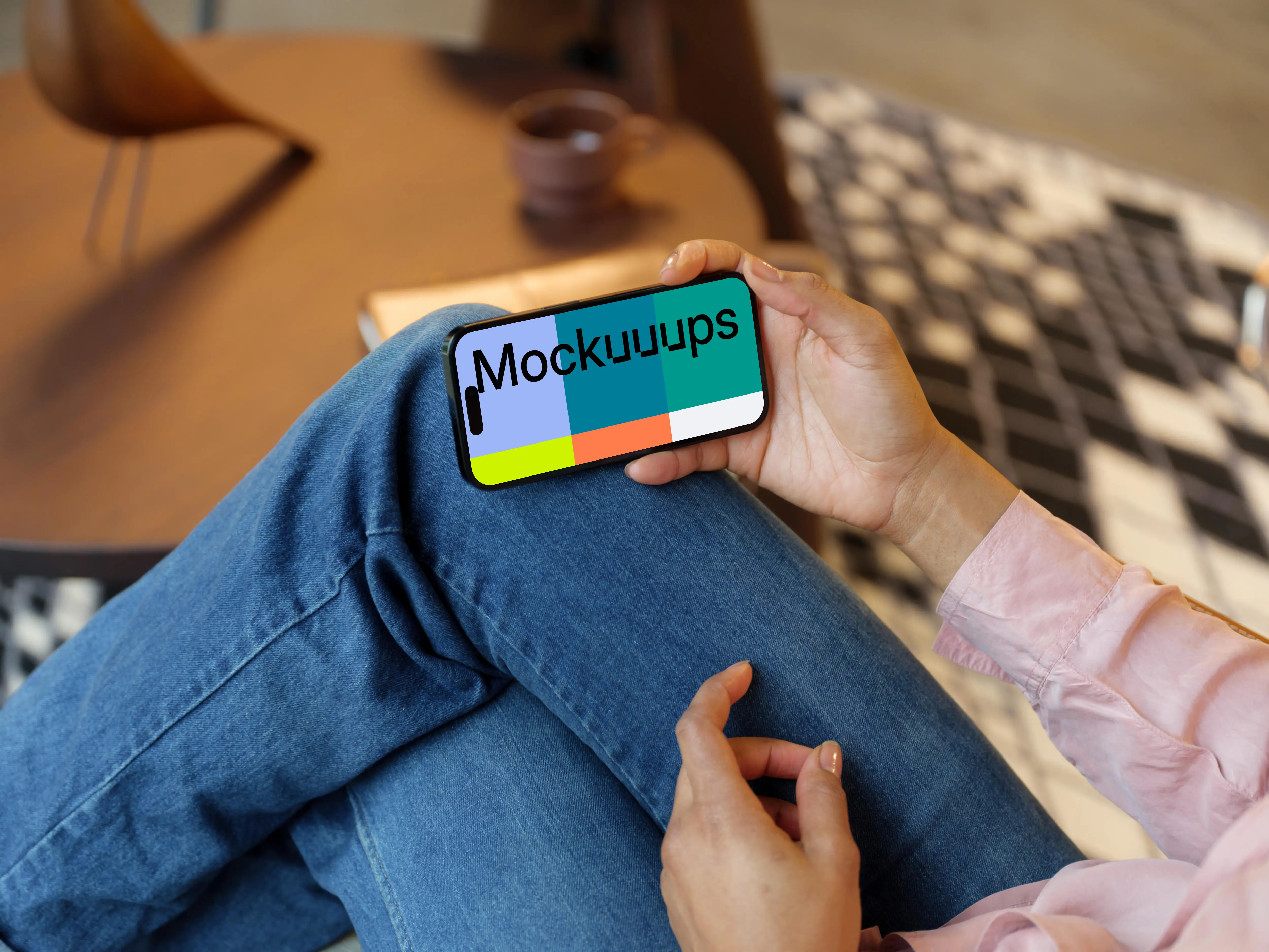 Hand holding an iPhone 14 Pro mockup