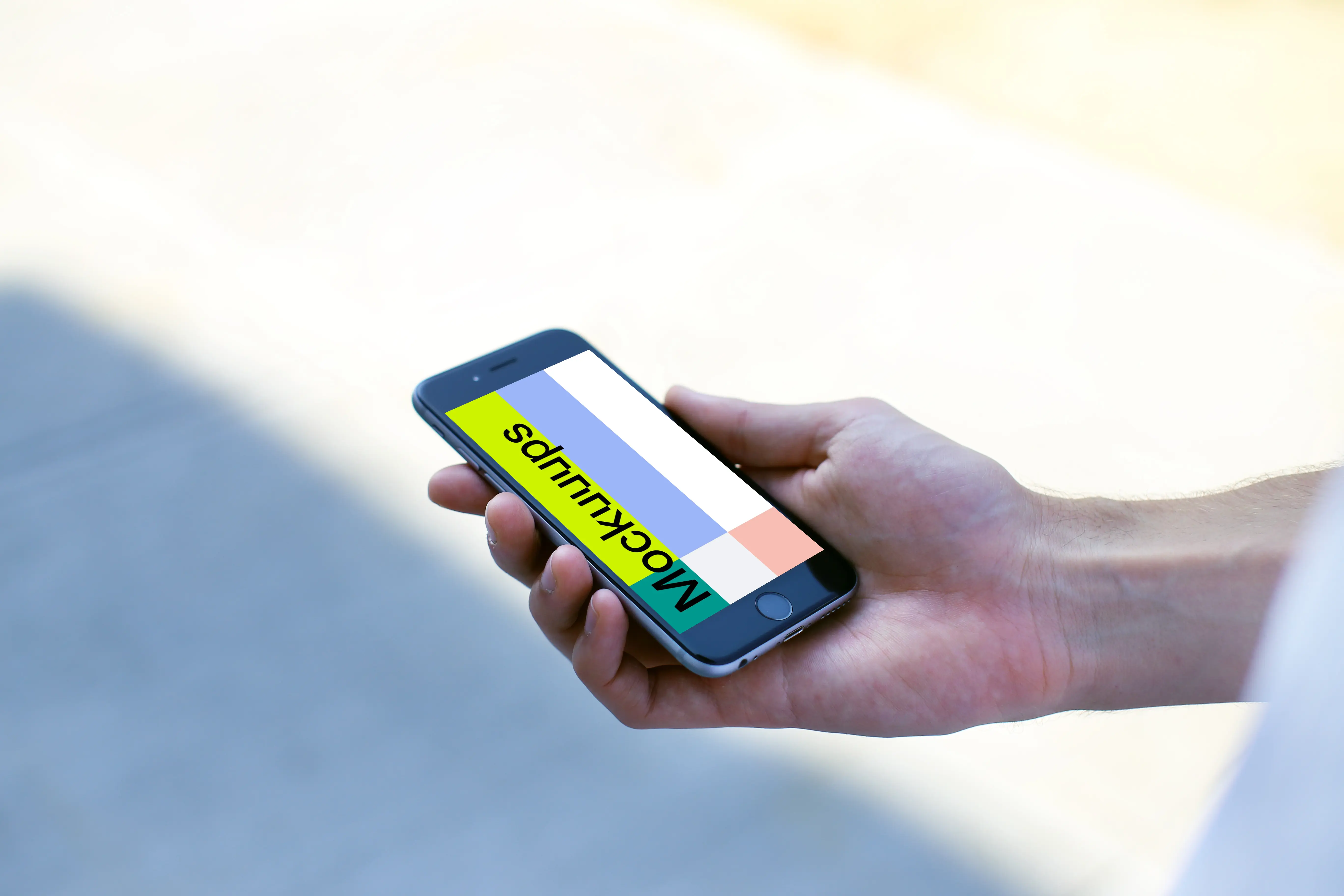 Holding a iPhone 6s mockup on the street