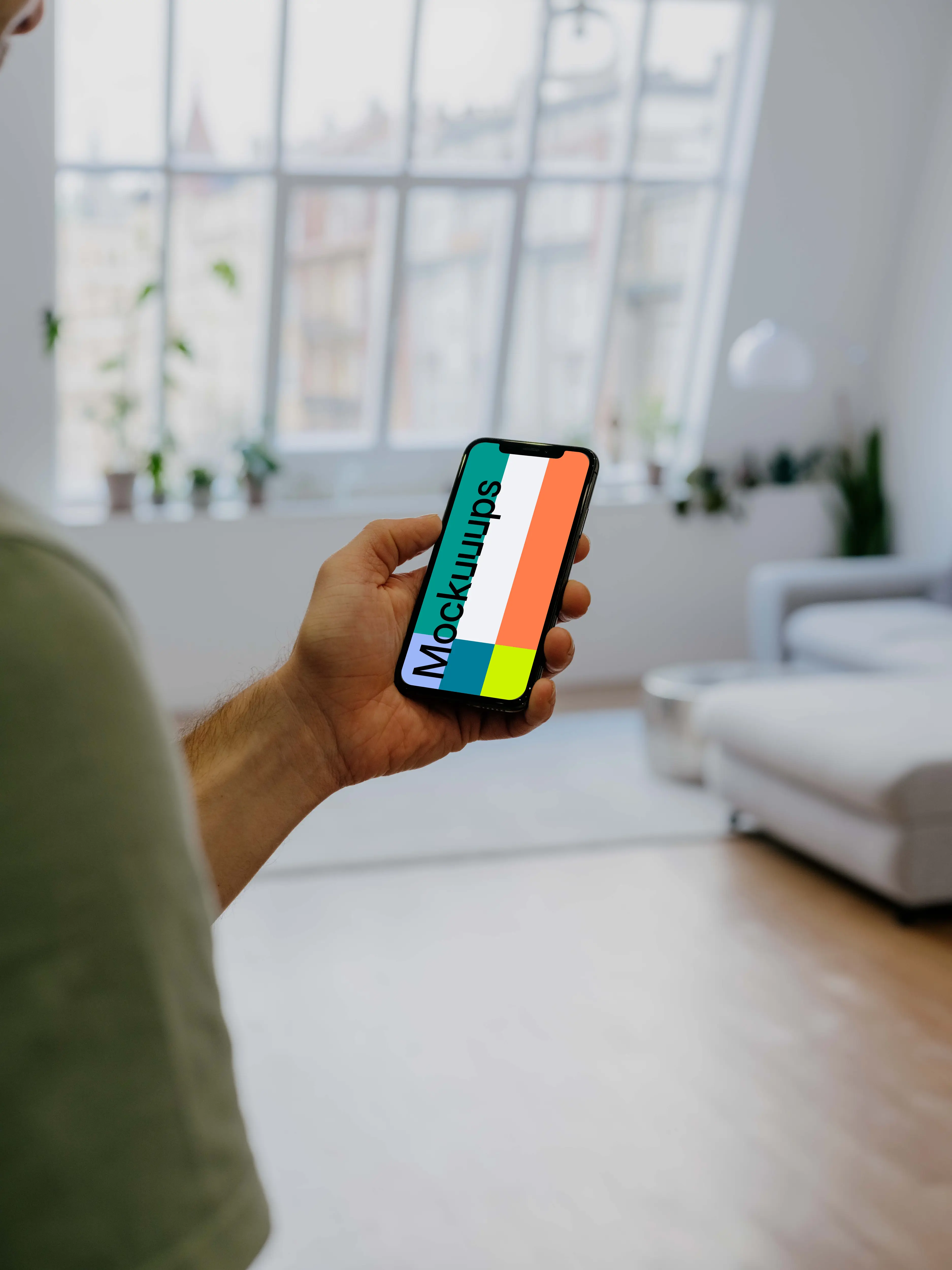 Holding iPhone 12 Pro Mockup in front of windows
