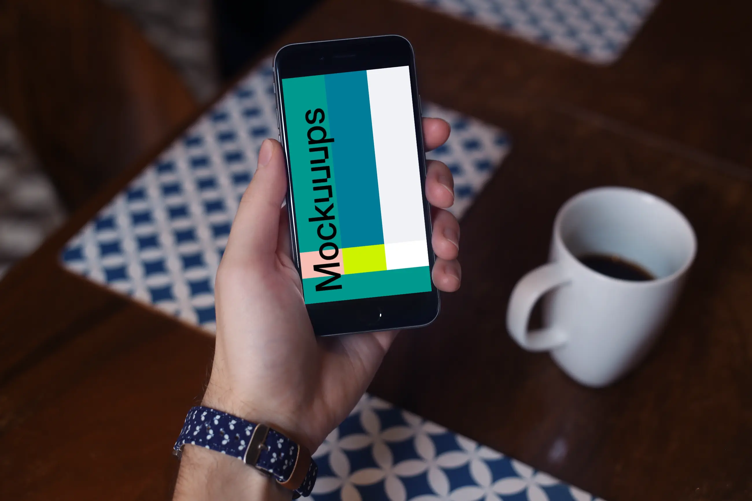 Holding iPhone 6 mockup and drinking coffee