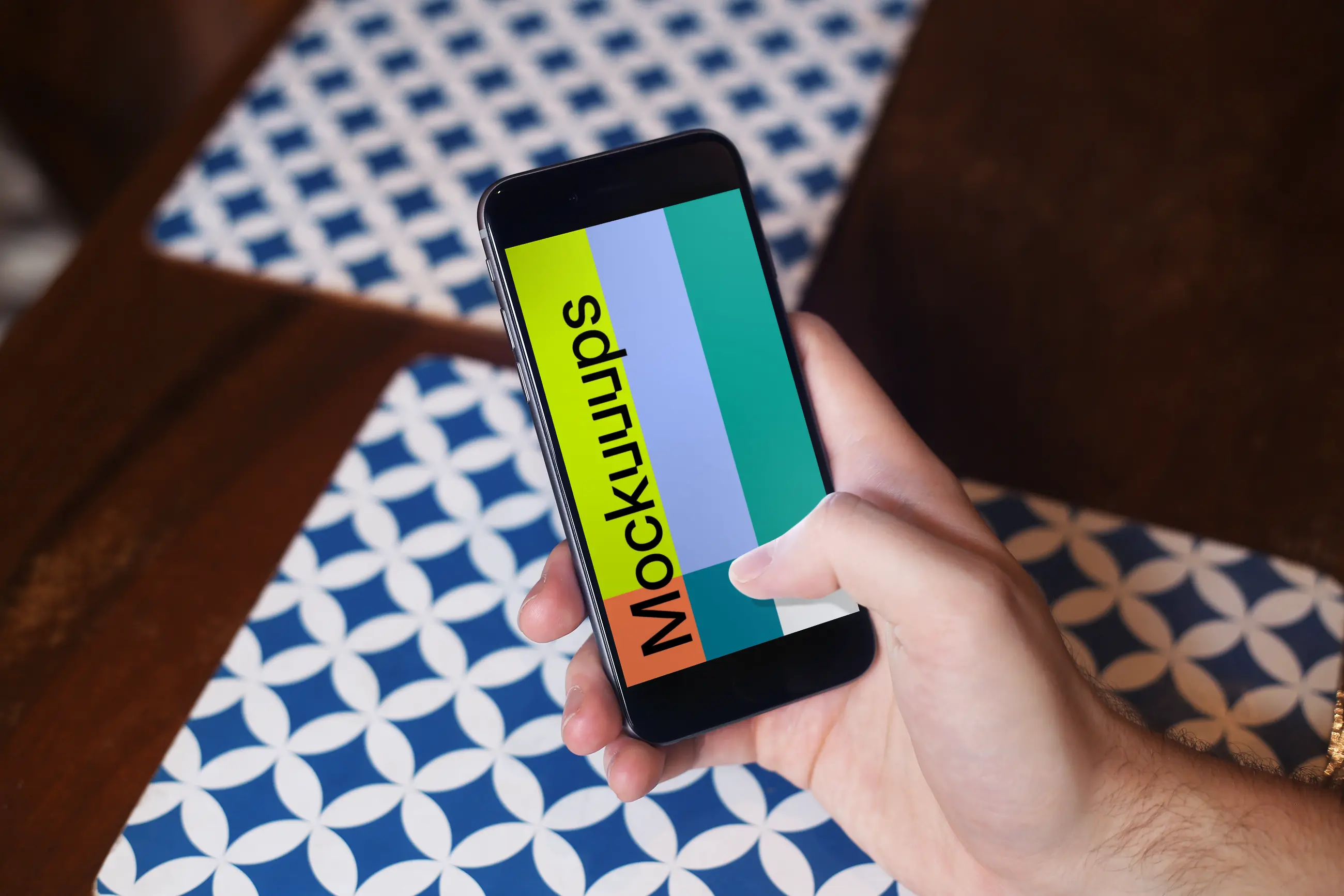 Holding iPhone 6 mockup at coffee