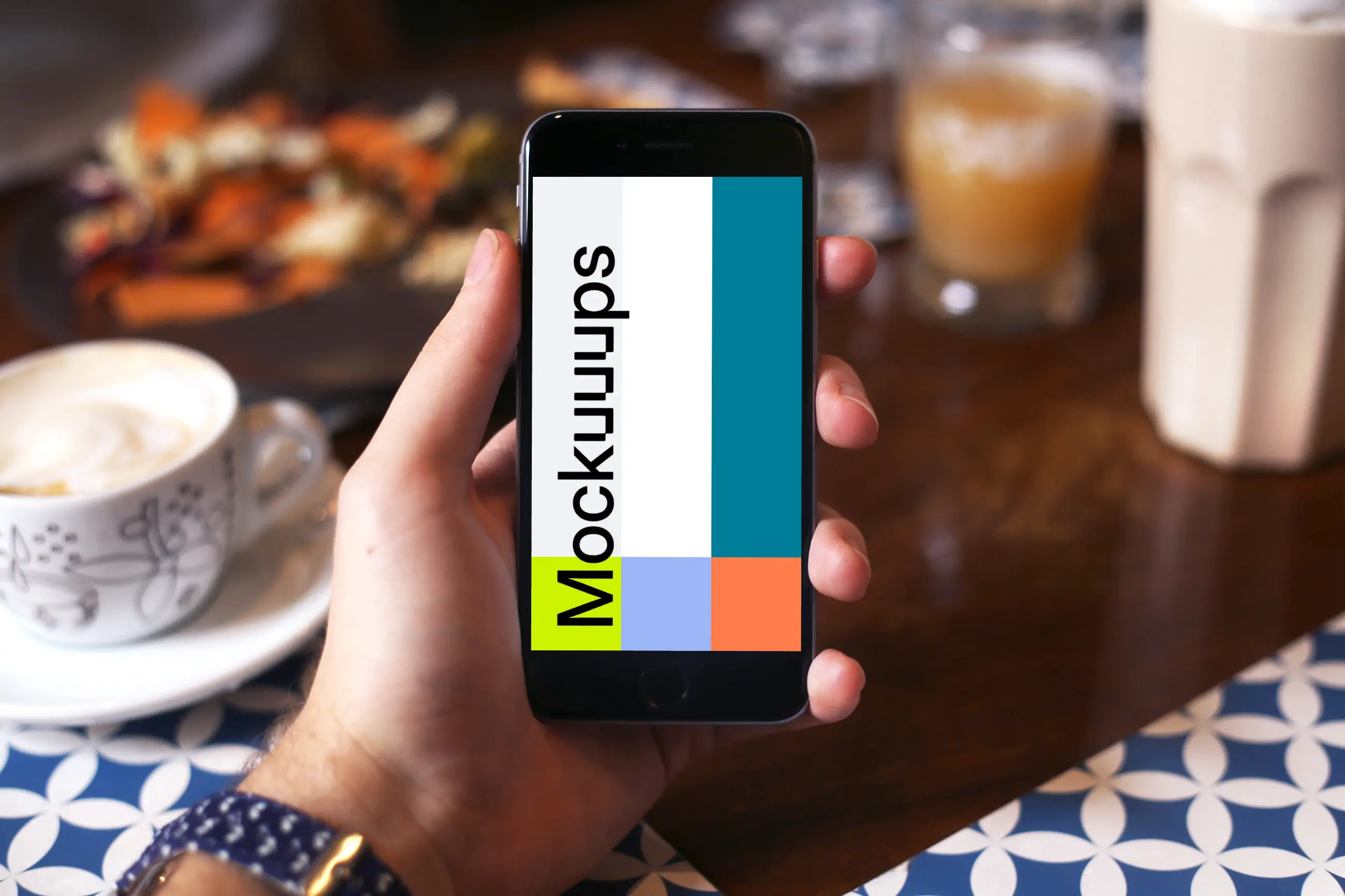 Holding iPhone 6 mockup at coffee