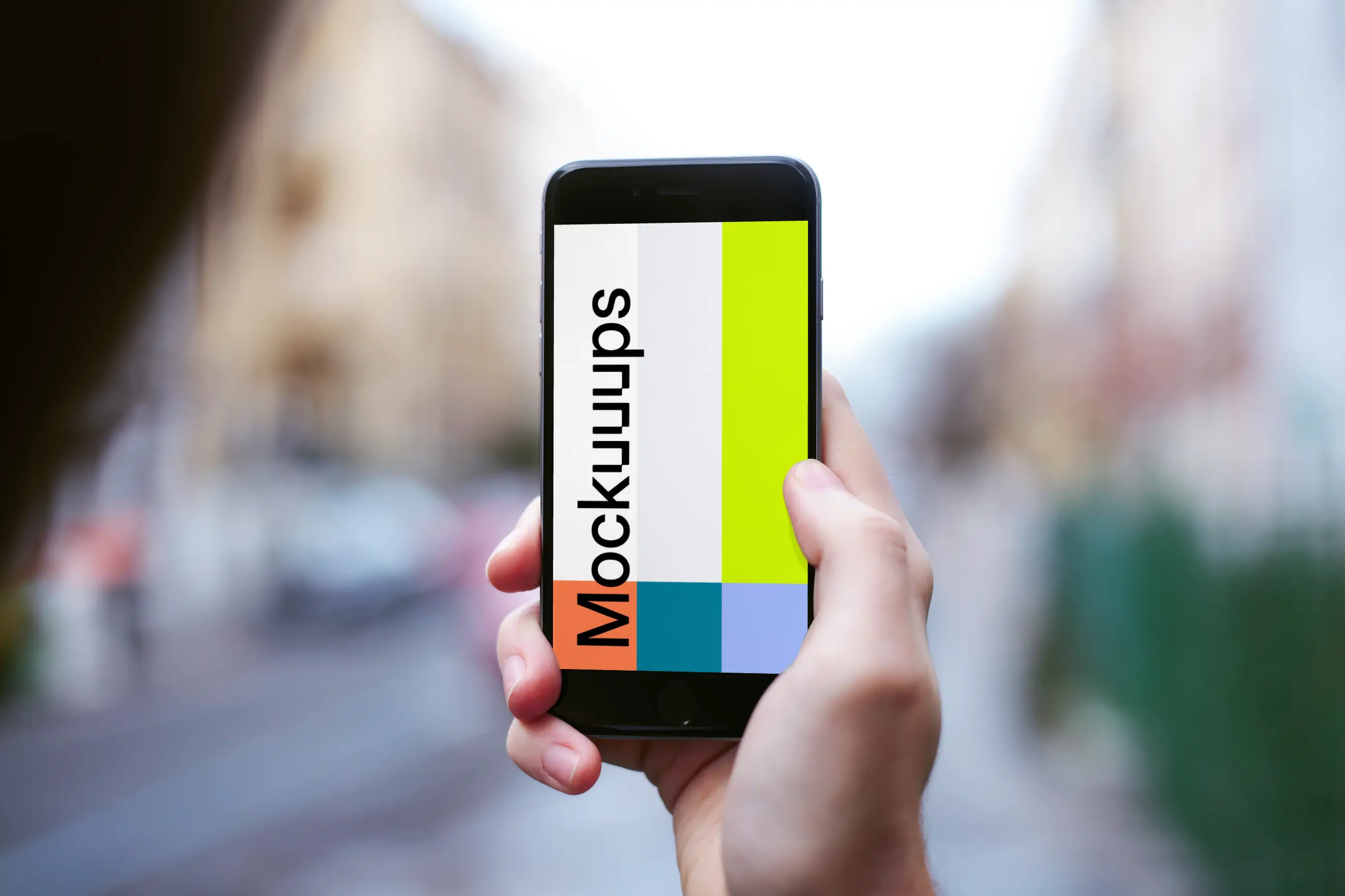 Holding iPhone 6 mockup on the street