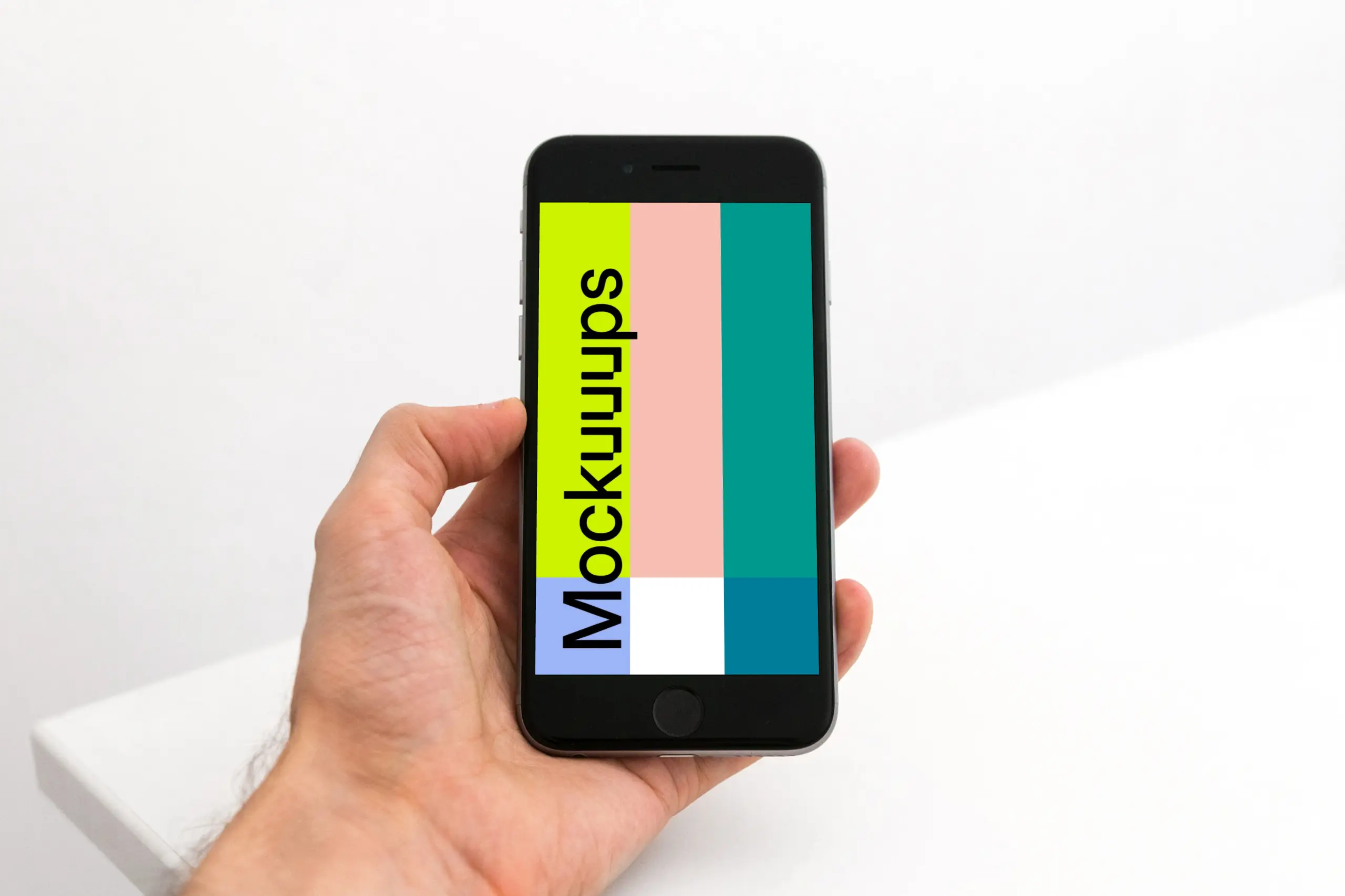 Holding iPhone 6s mockup in the office