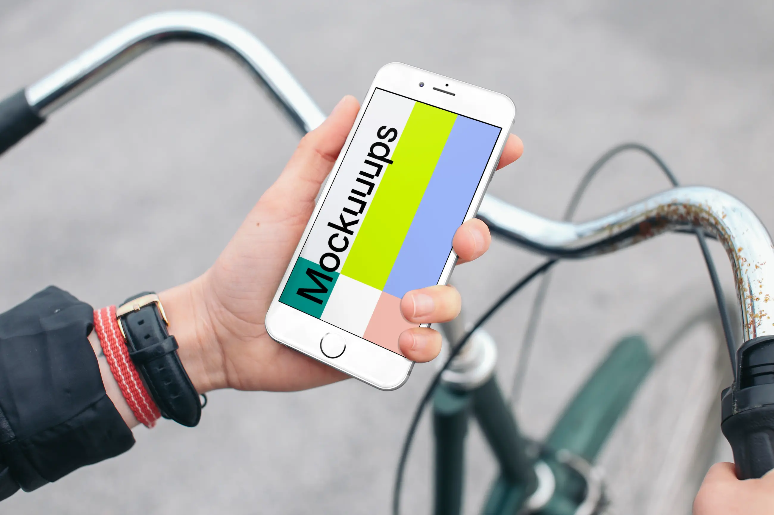 Holding iPhone 6s mockup on a Bike