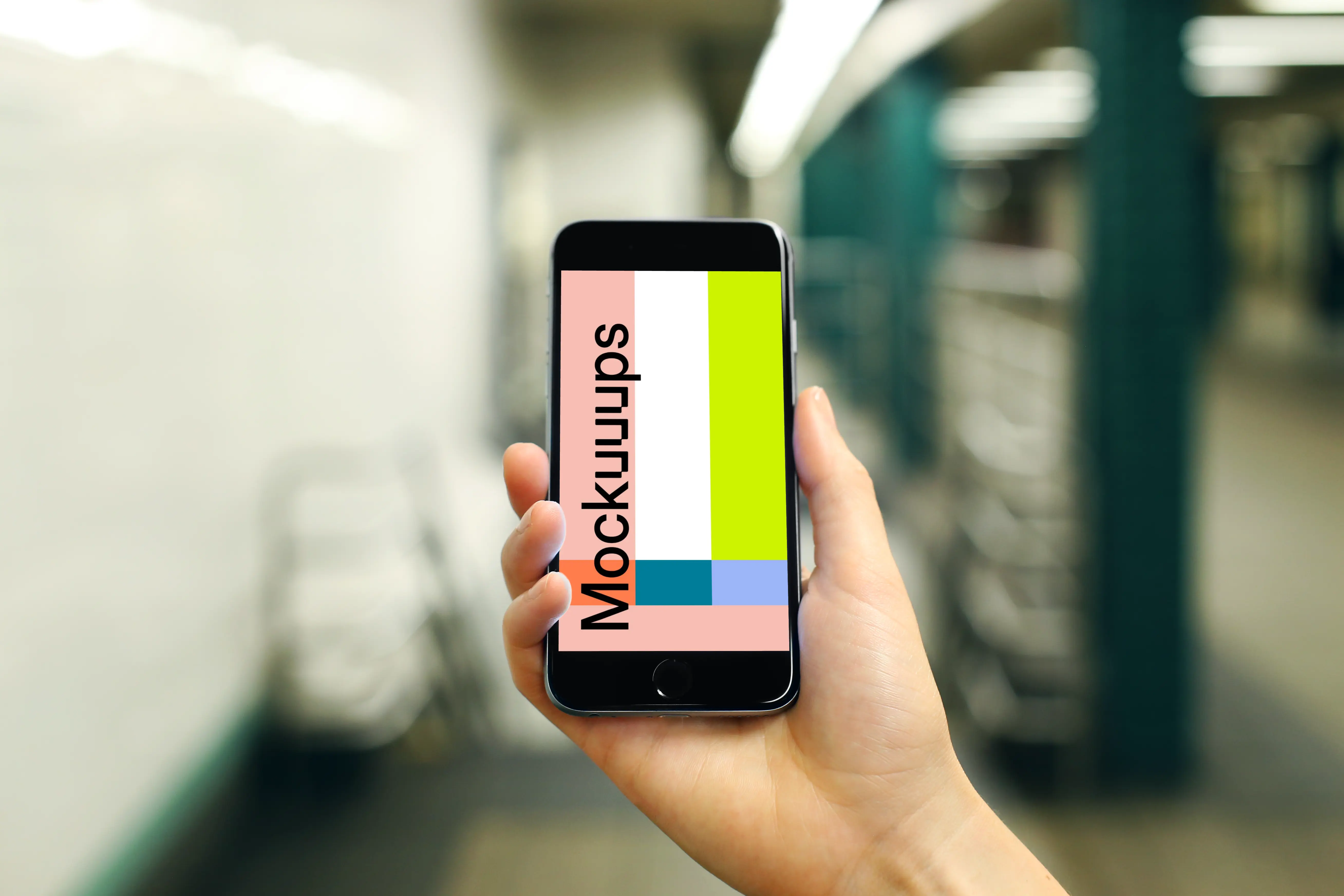 Holding iPhone 6s mockup on a Train Station