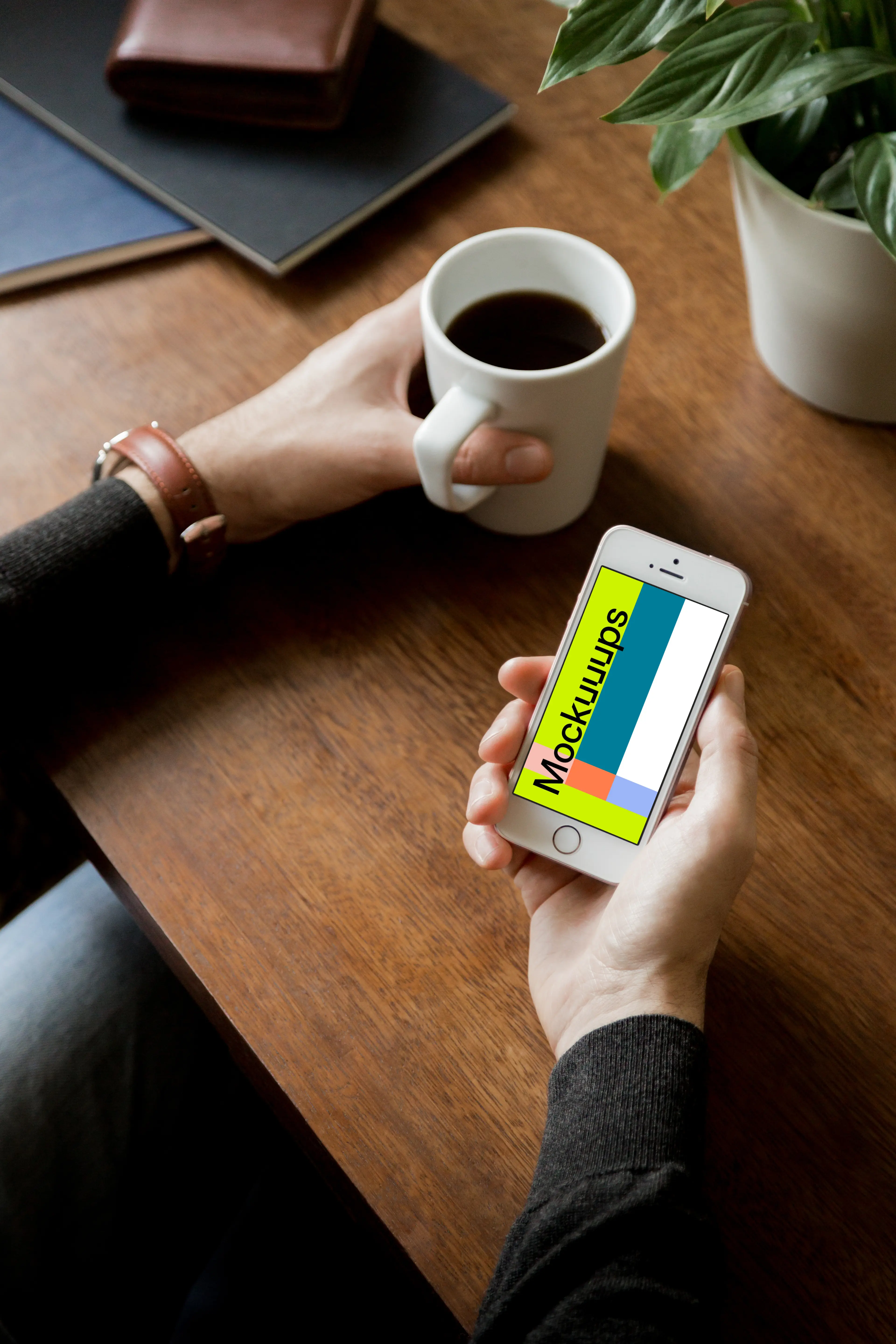 Holding iPhone SE mockup and drinking black coffee