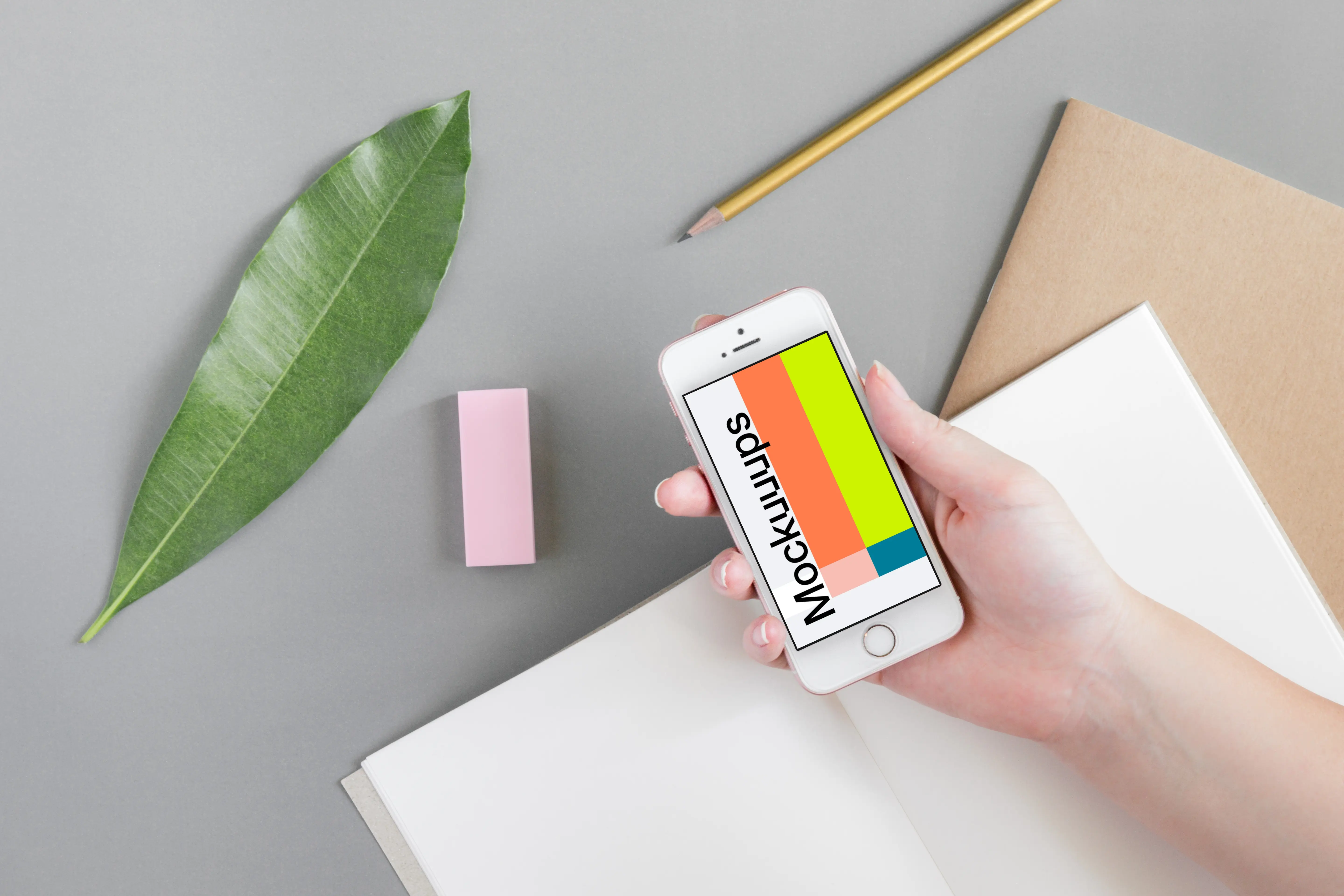 Holding iPhone SE mockup over the journal