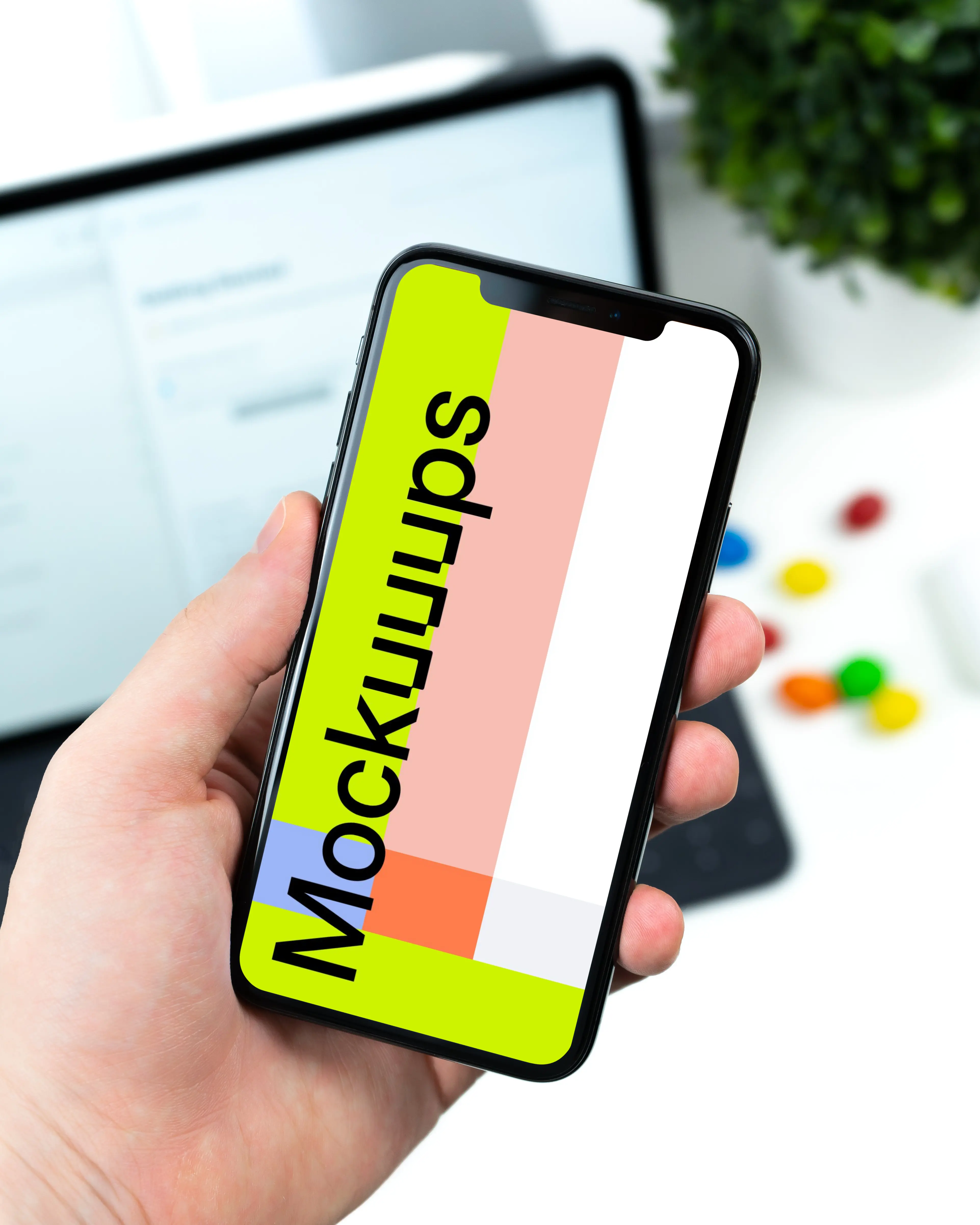 Holding iPhone XS mockup