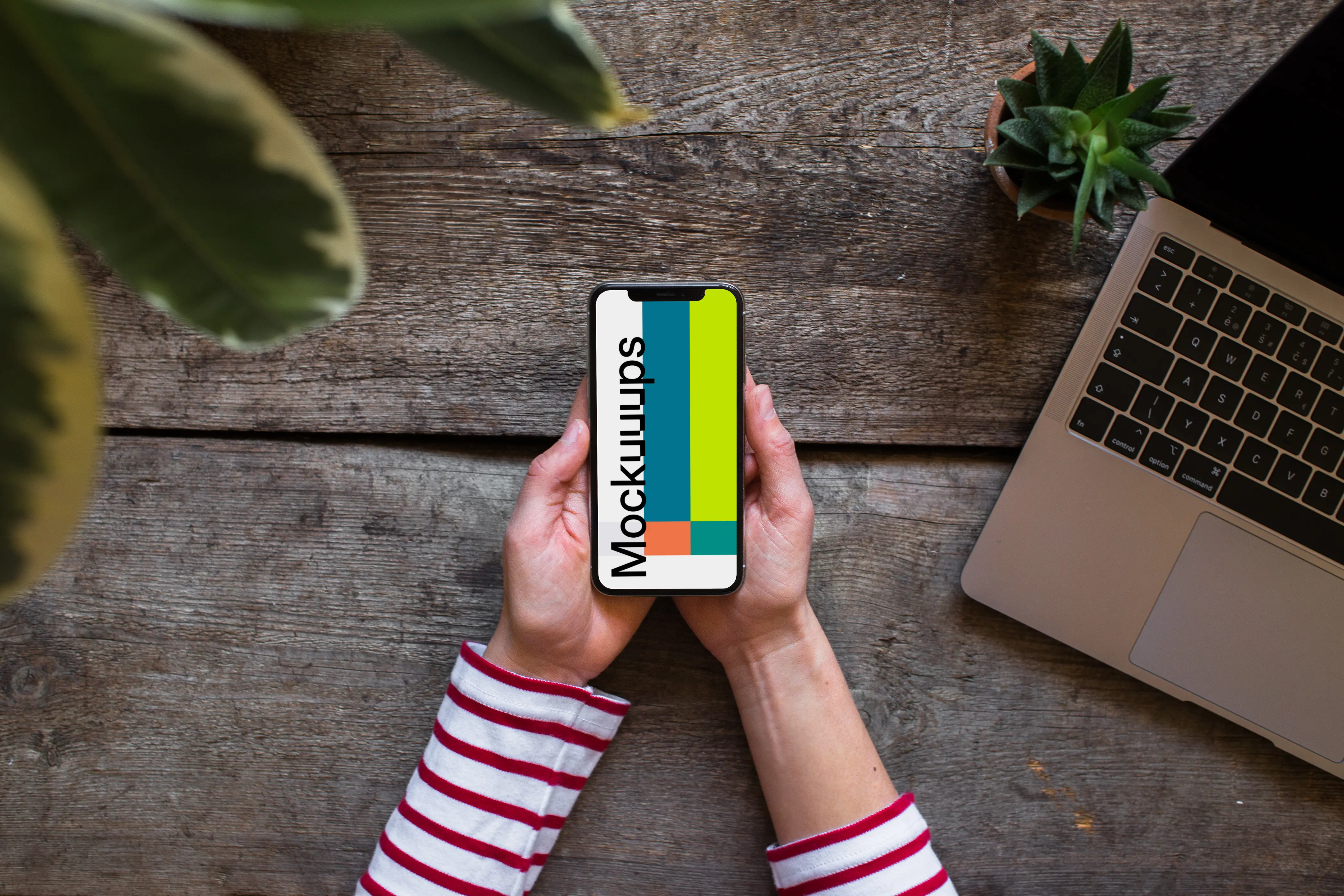 Holding iPhone XS mockup with both hands