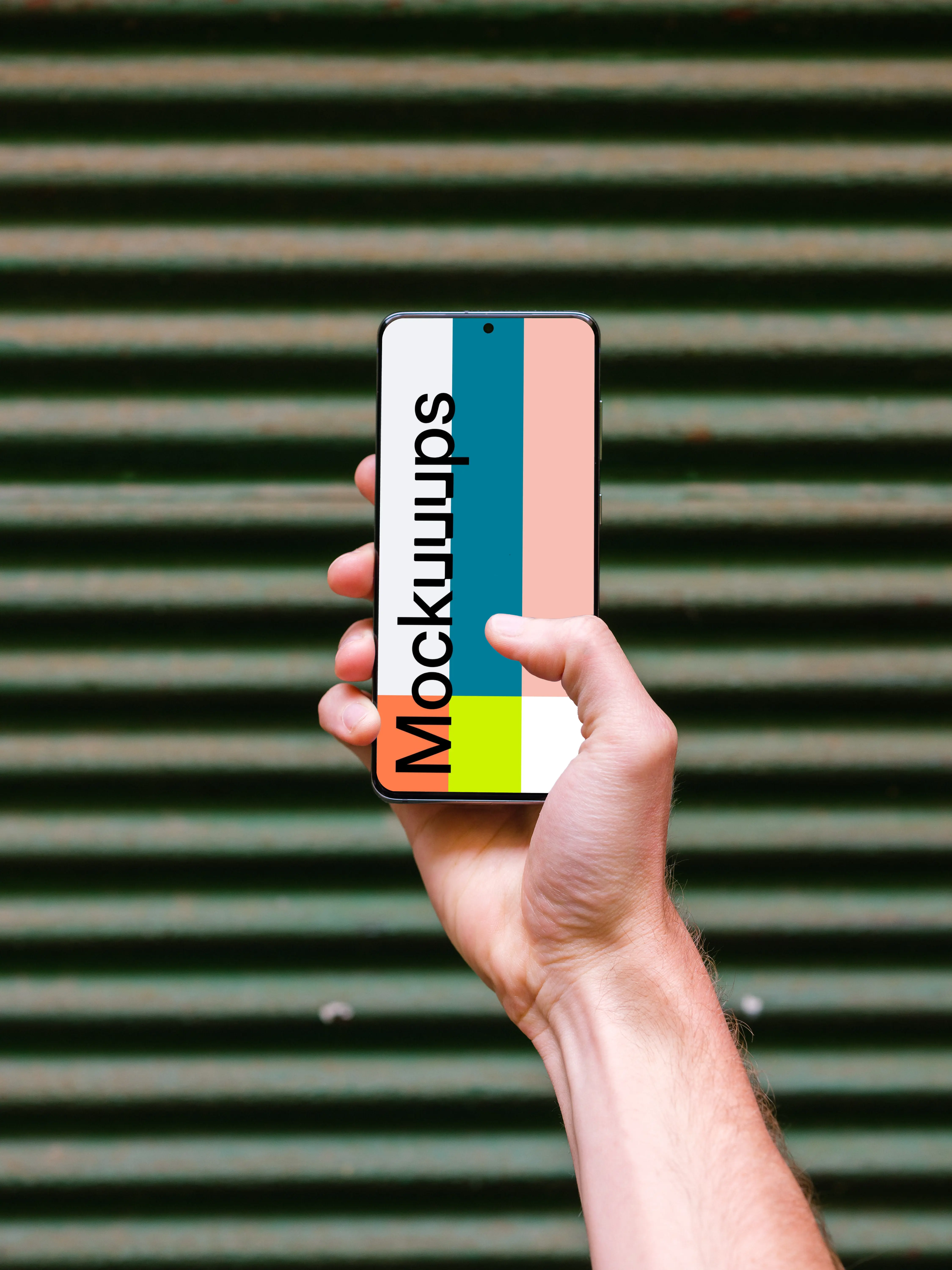 Holding Samsung Galaxy S20 mockup against metal fence