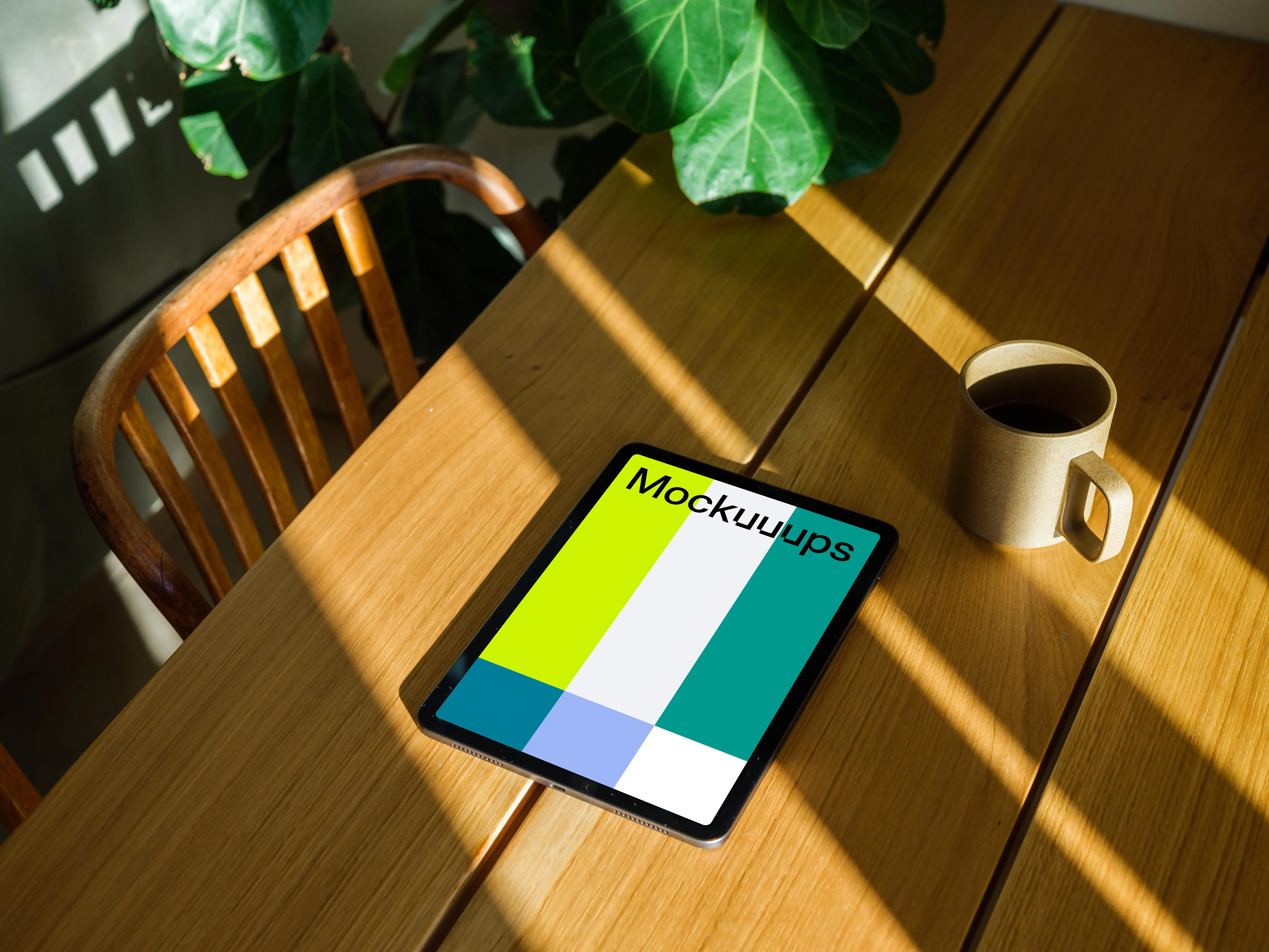 iPad Air mockup beside a cup of coffee and a plant in the background