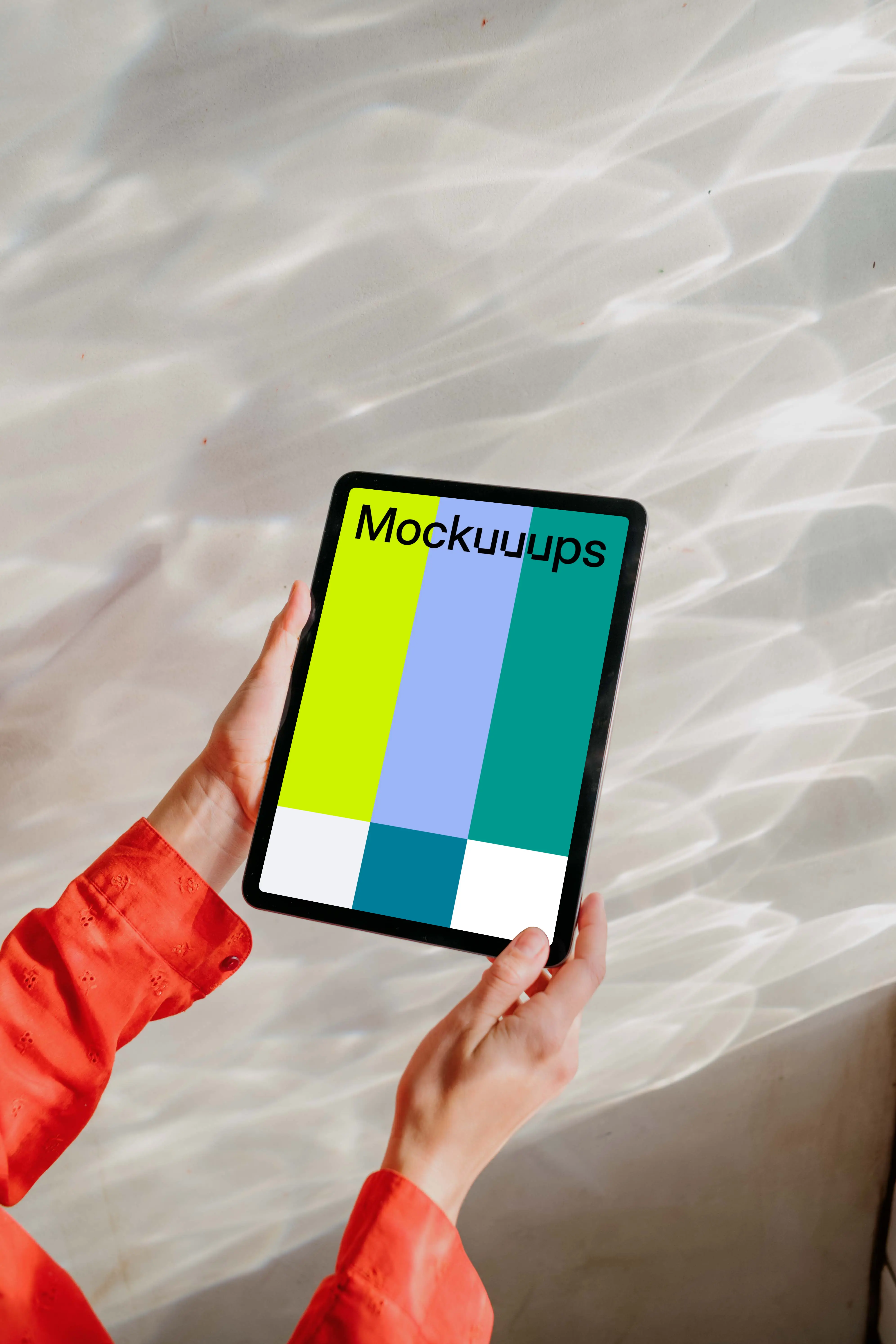 Free iPad Air mockup held by user against a bright silver background 