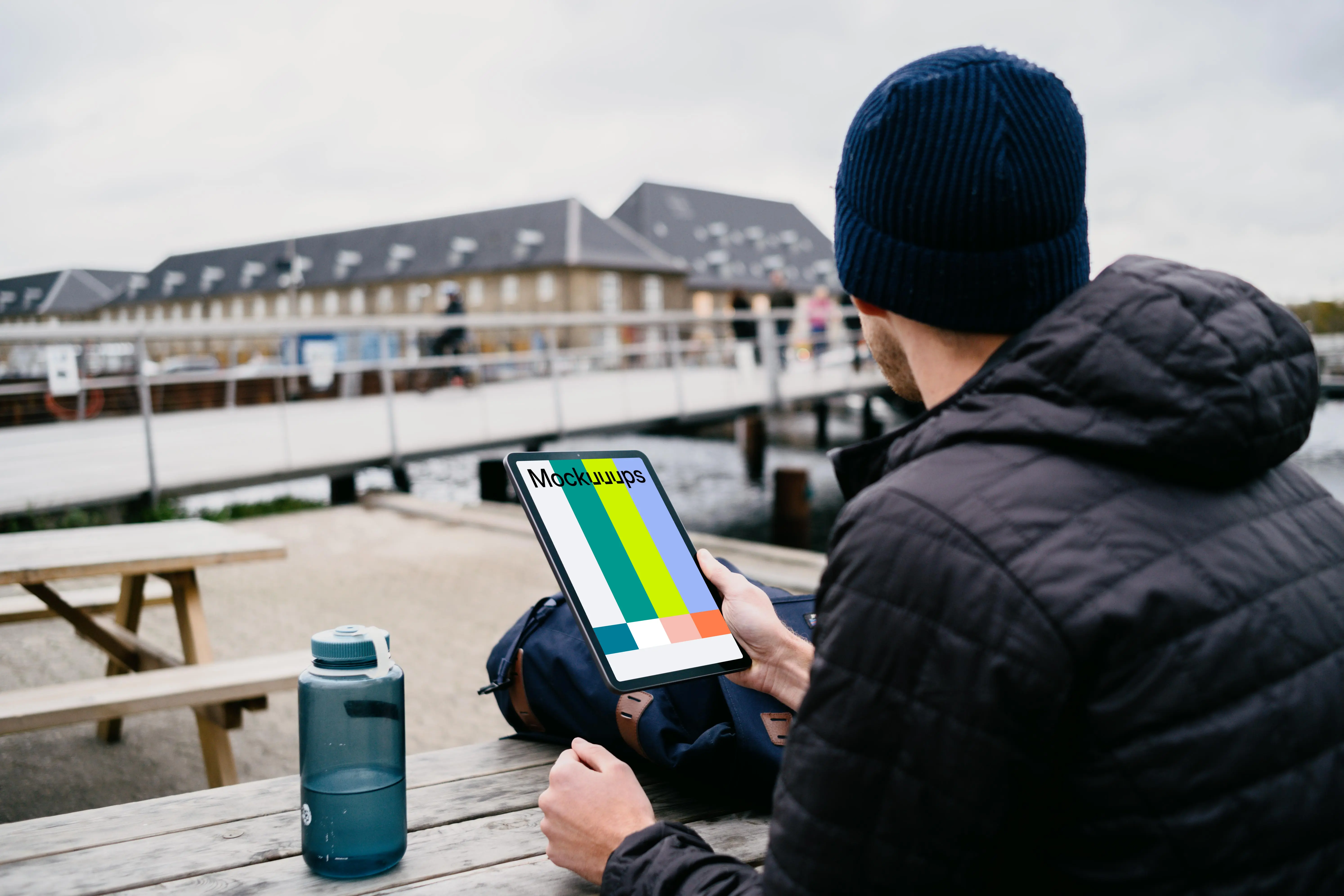  iPad Air mockup help by a user’s hand outside