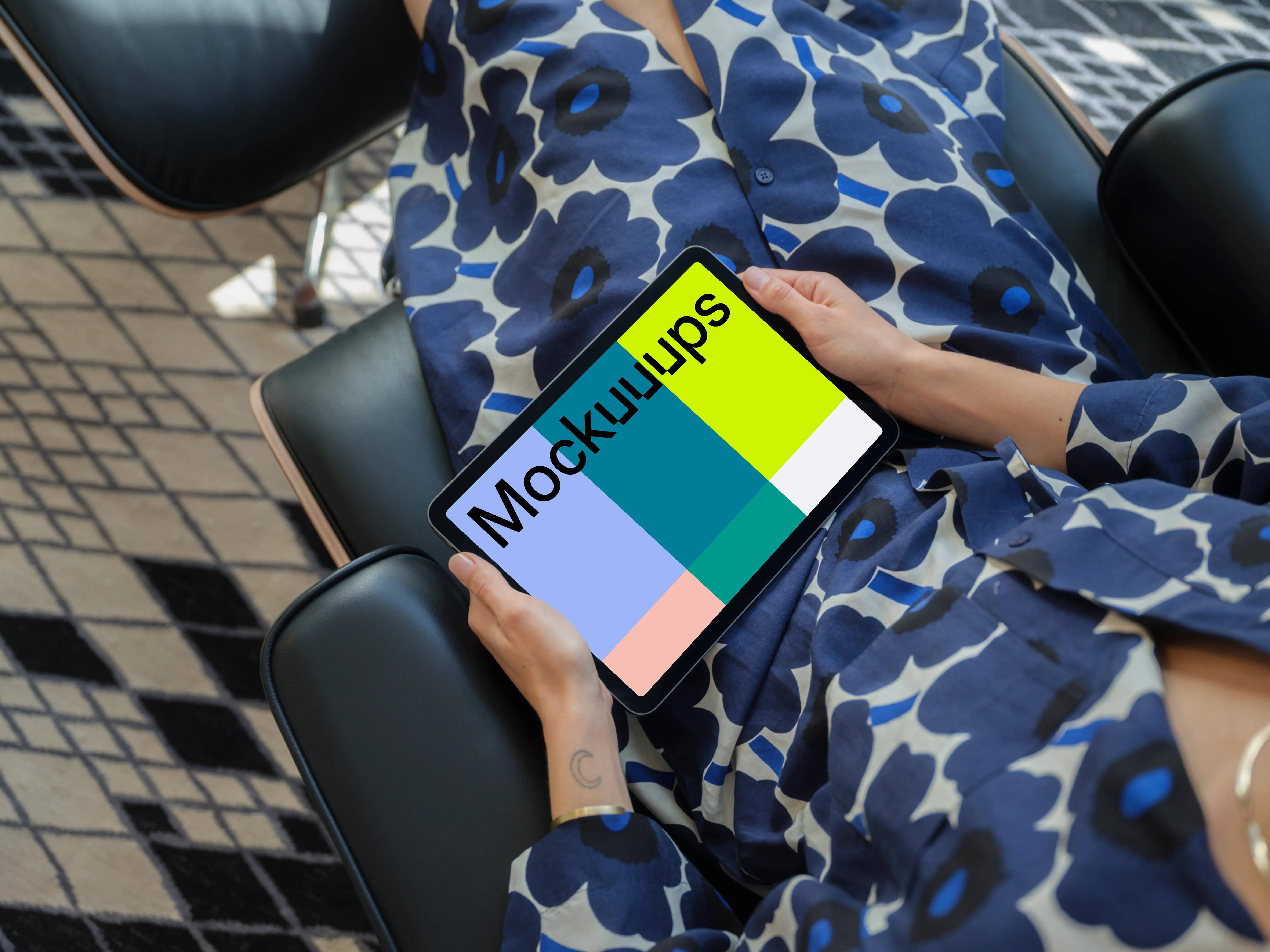 iPad Air mockup in a woman's hand on a modern chair