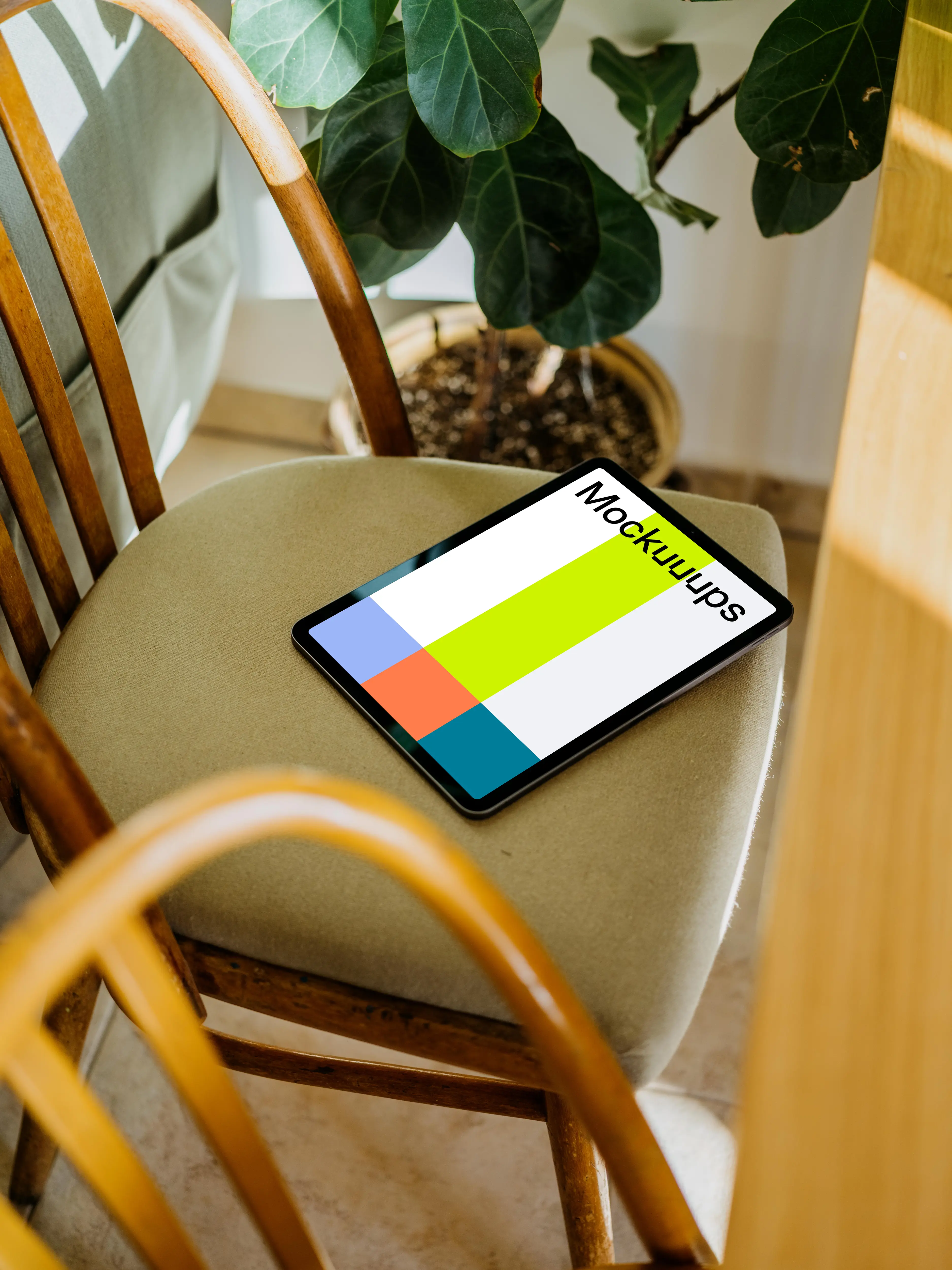 iPad Air mockup on a chair with a plant in the background