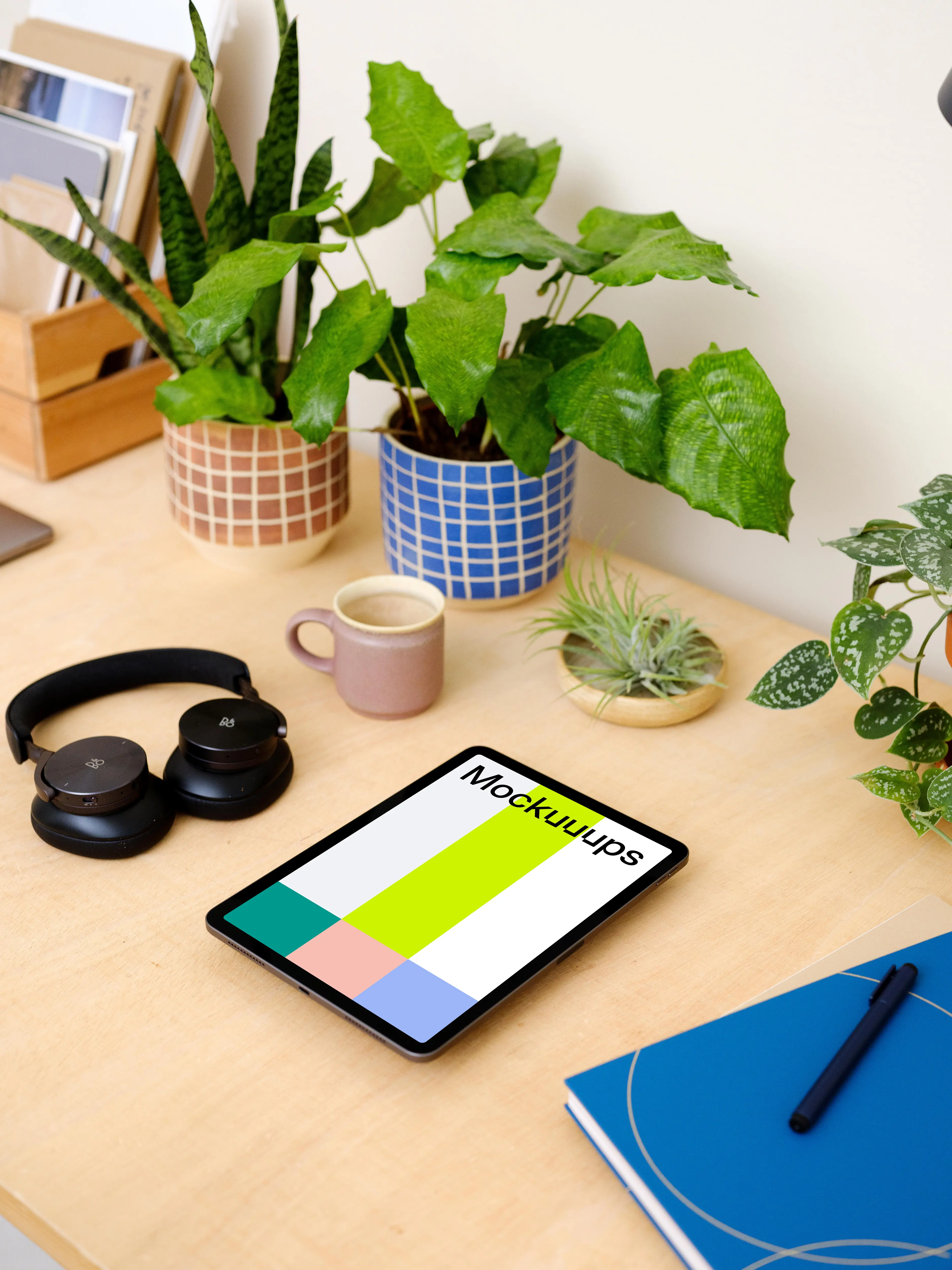 iPad Air mockup on a table surrounded with potted plants