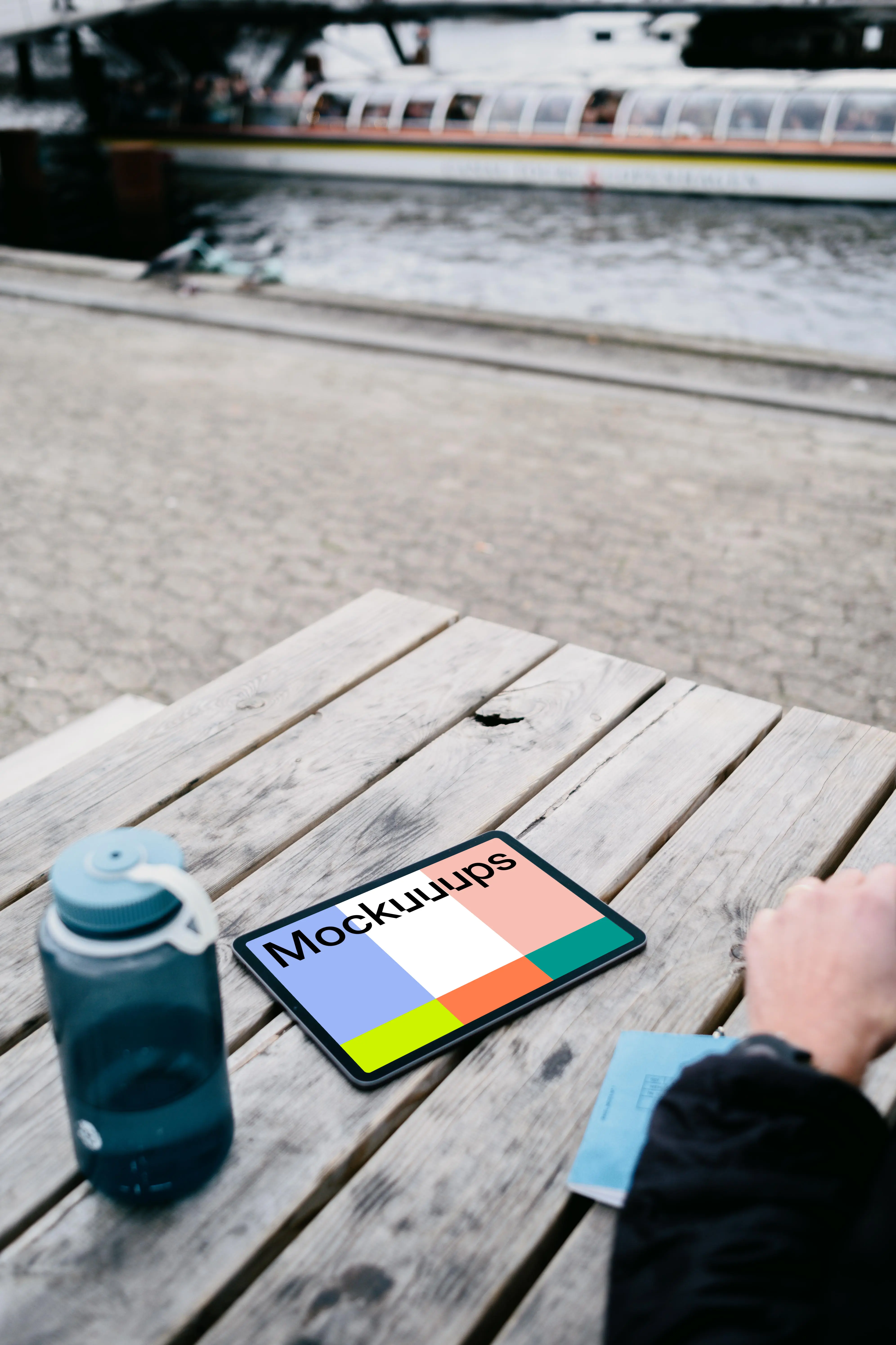 iPad Air mockup on a table with a bottle at the side 
