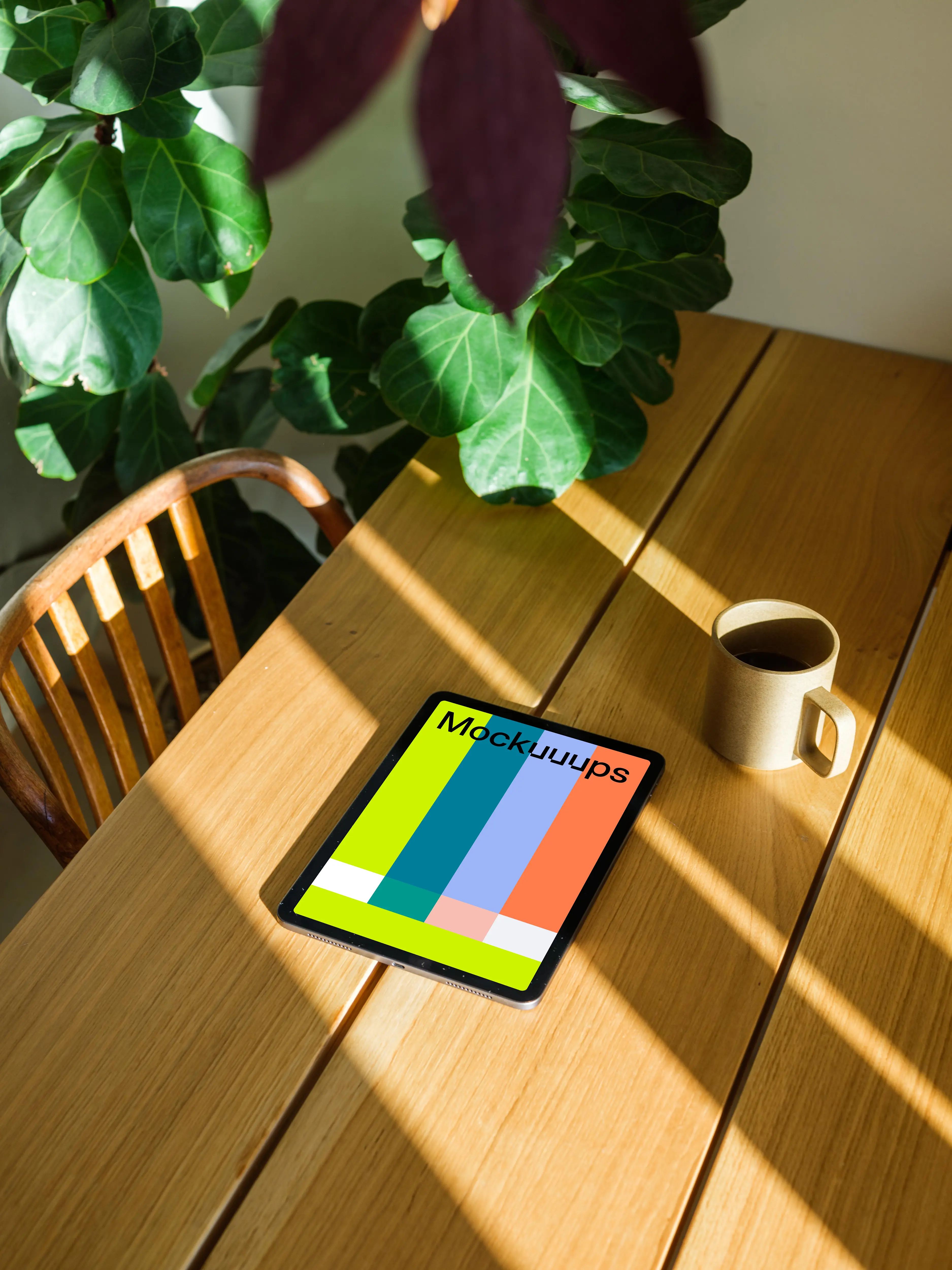 iPad Air mockup on a wooden table beside a coffee mug