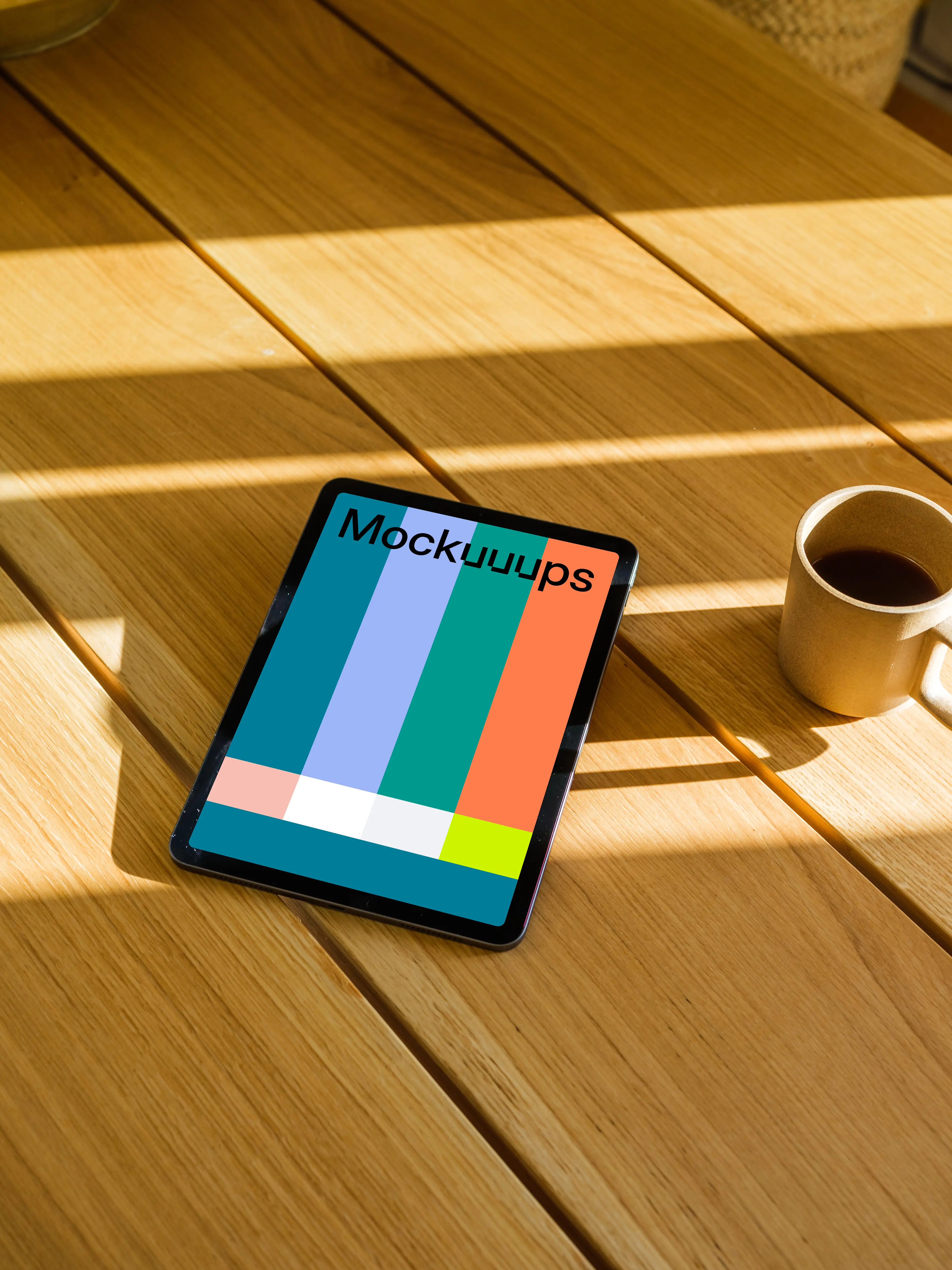 iPad Air mockup on a wooden table beside a mug of coffee