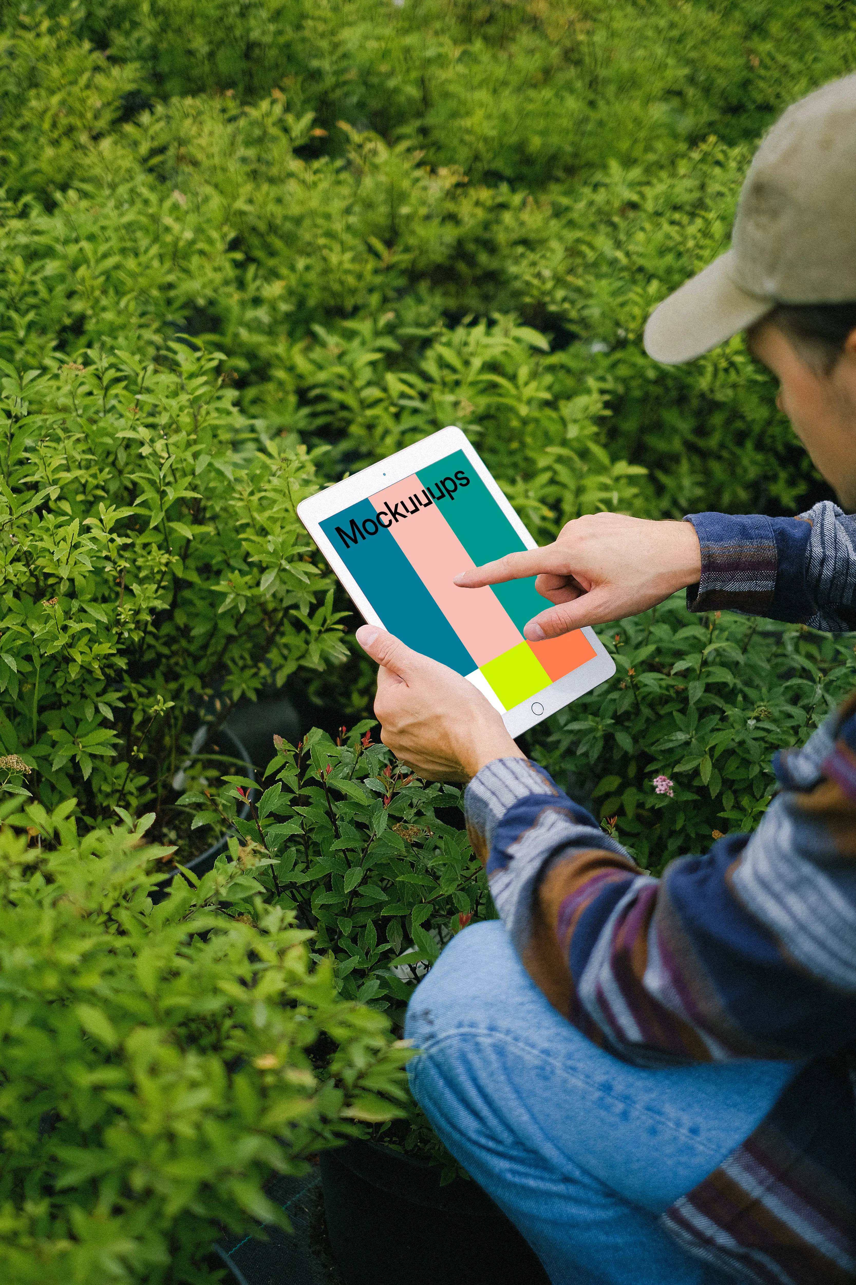 iPad Mini mockup held by a user in a garden 