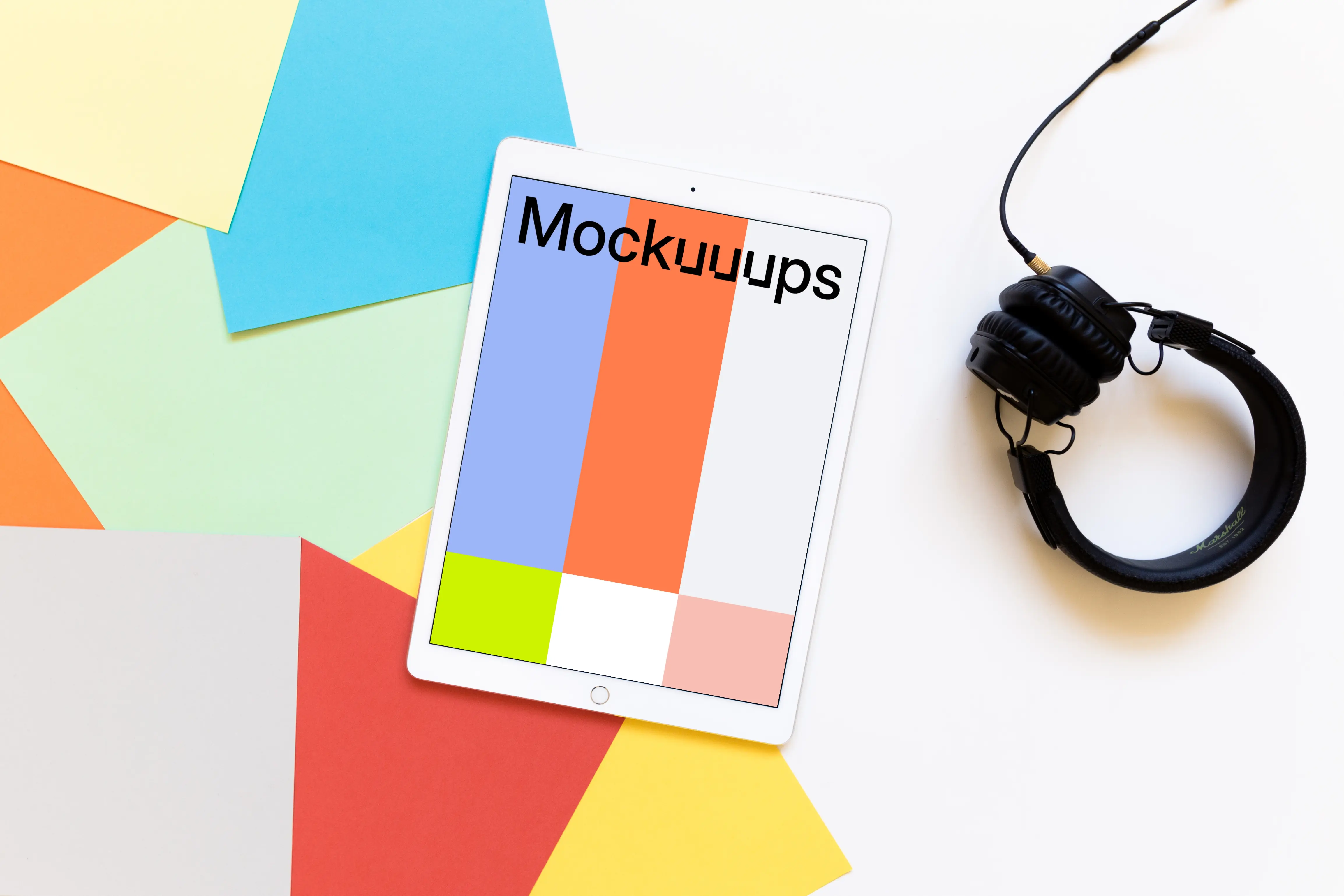 iPad Pro mockup with headphones on light desk