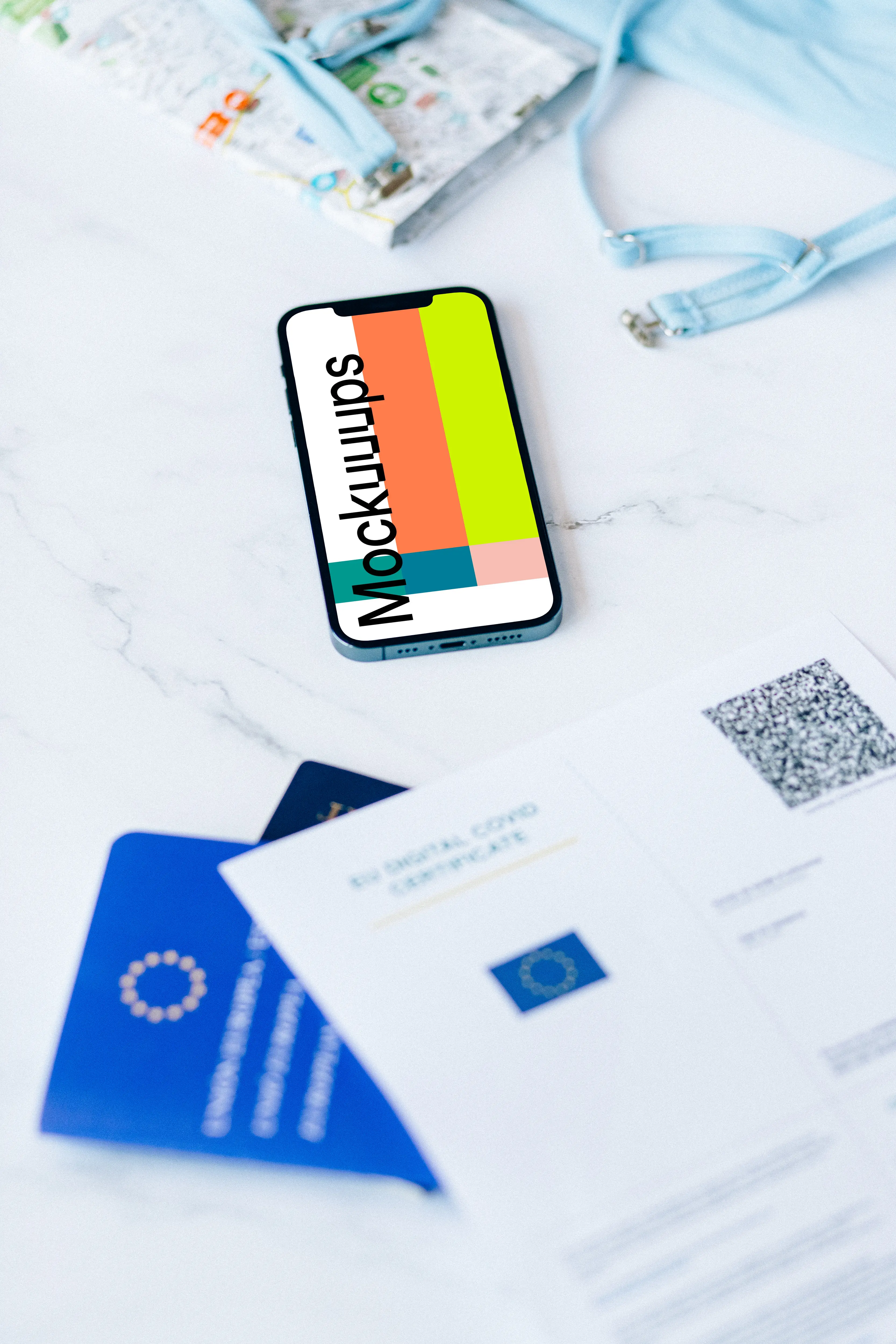 iPhone 12 Pro mockup on a white table beside a bikini