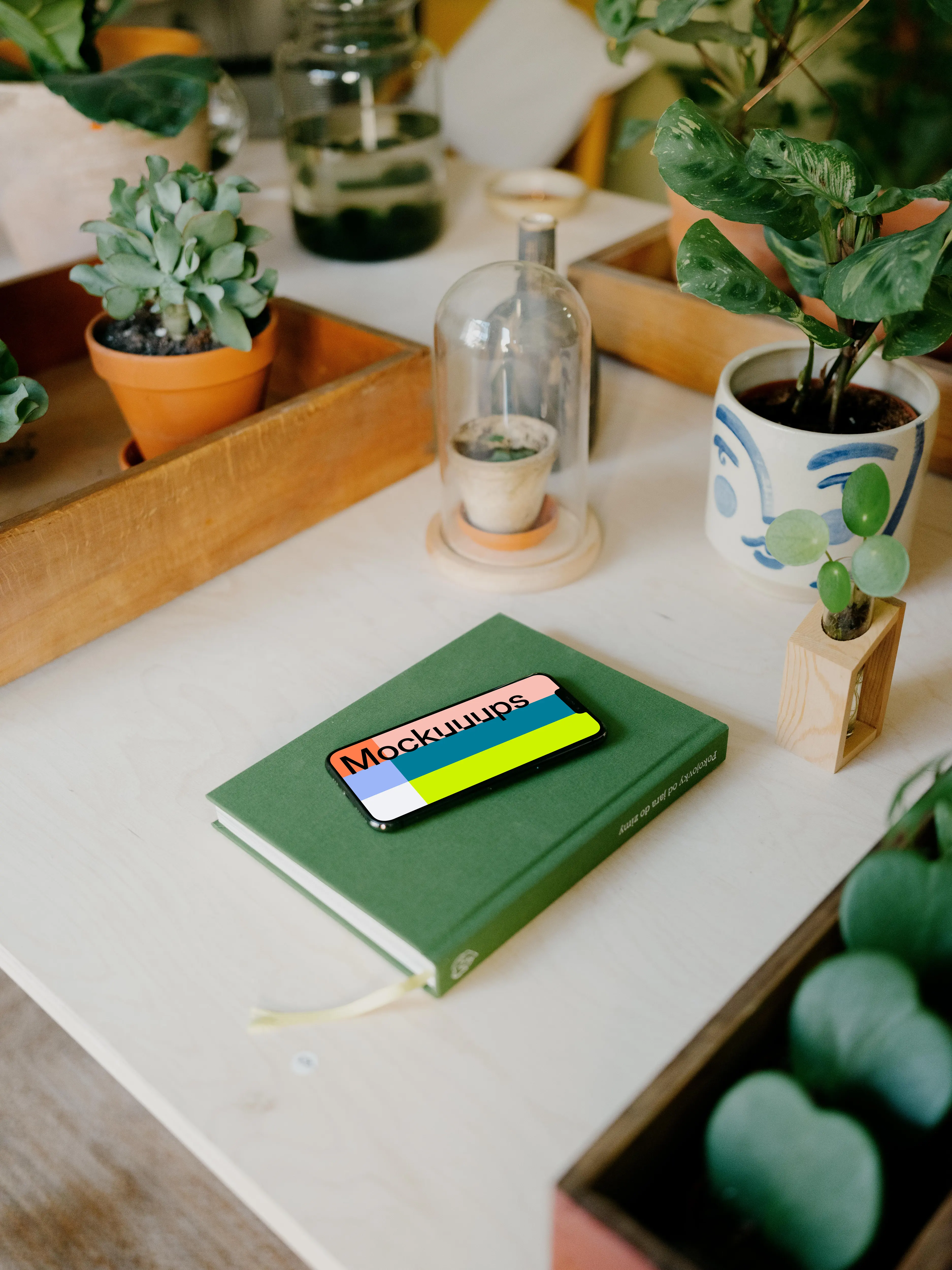 iPhone 13 Pro max mockup on a green notebook