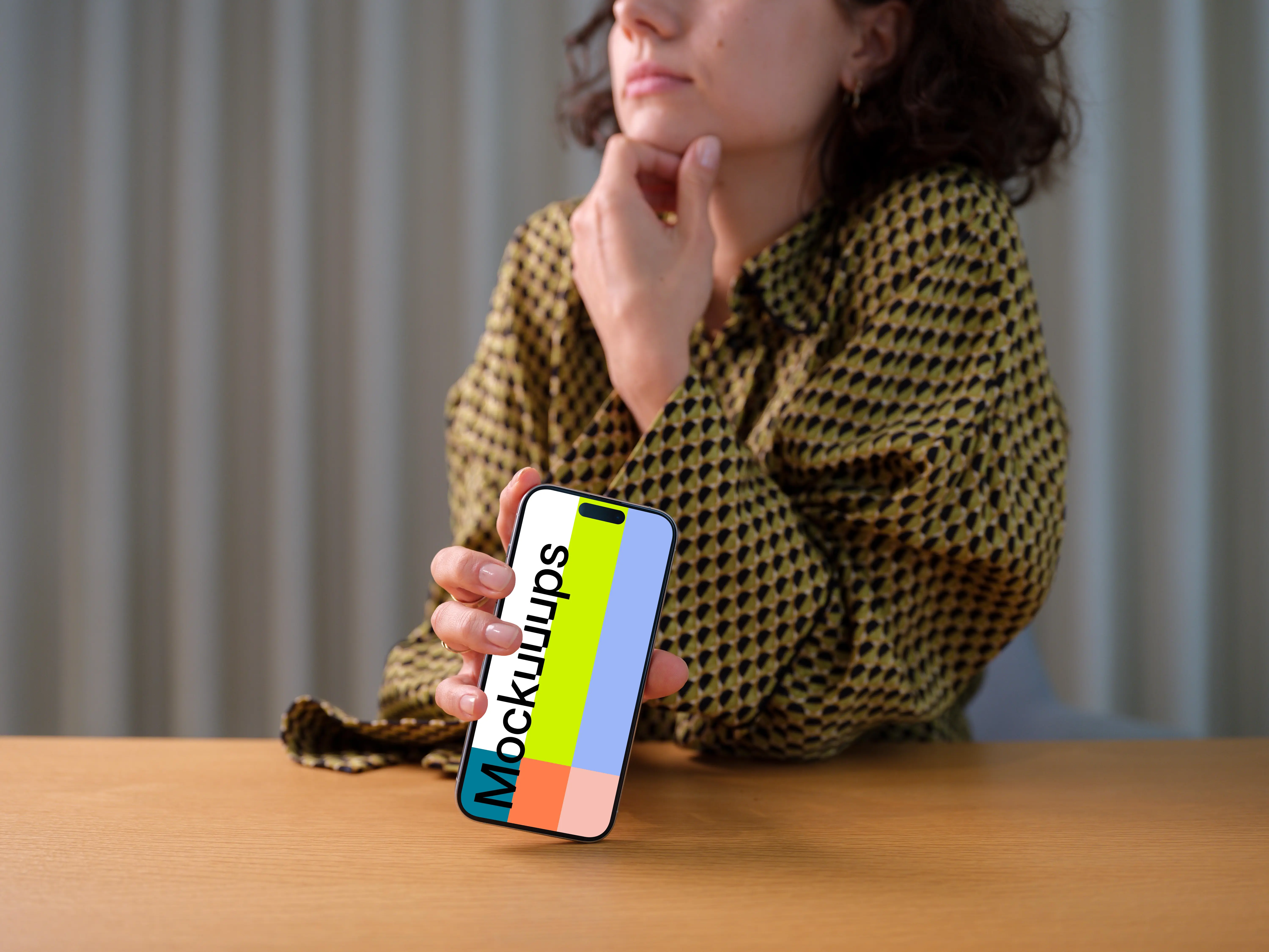 iPhone 15 Pro mockup in a woman's hand with thoughtful pose