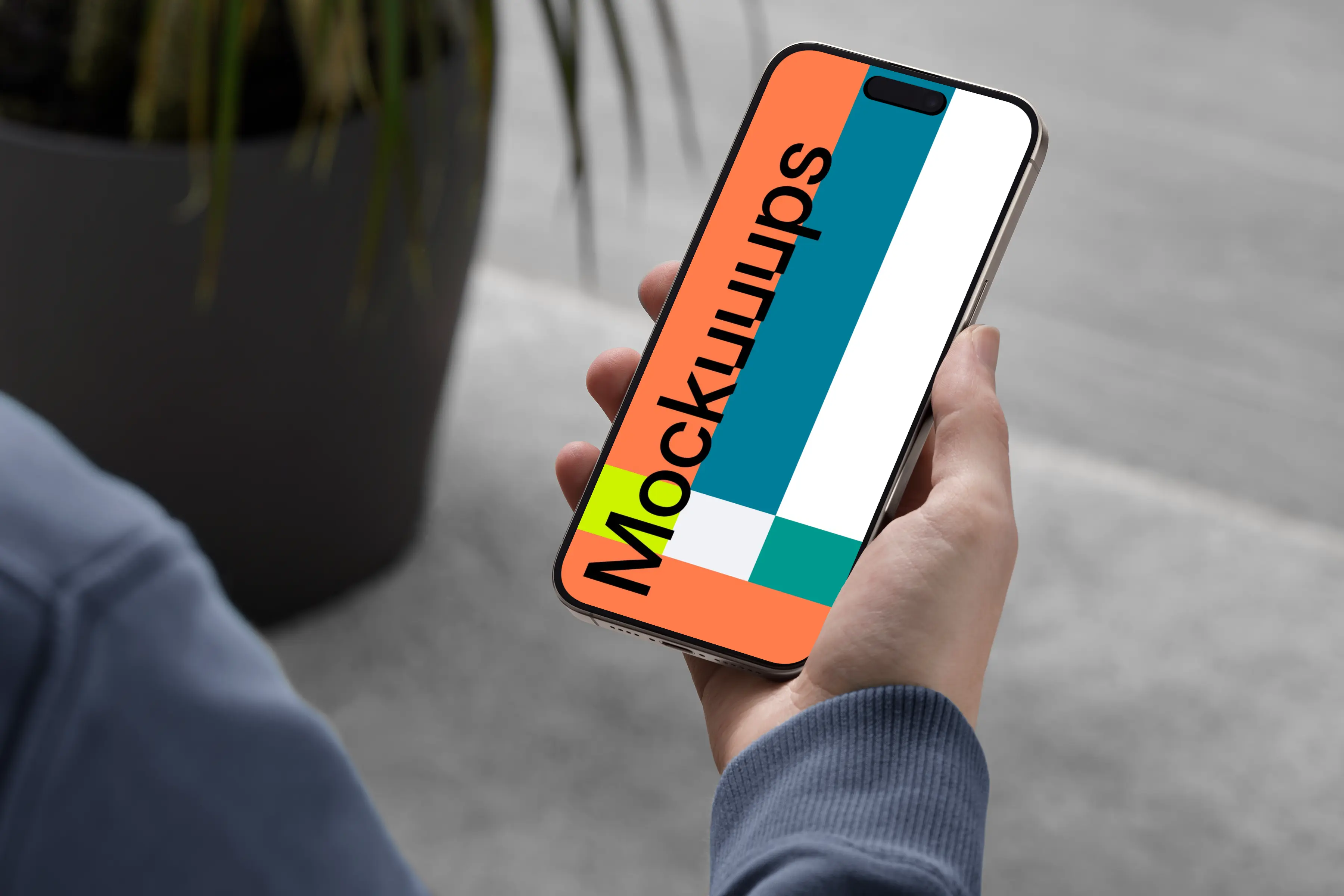 iPhone 15 Pro mockup in male hand with modern decor