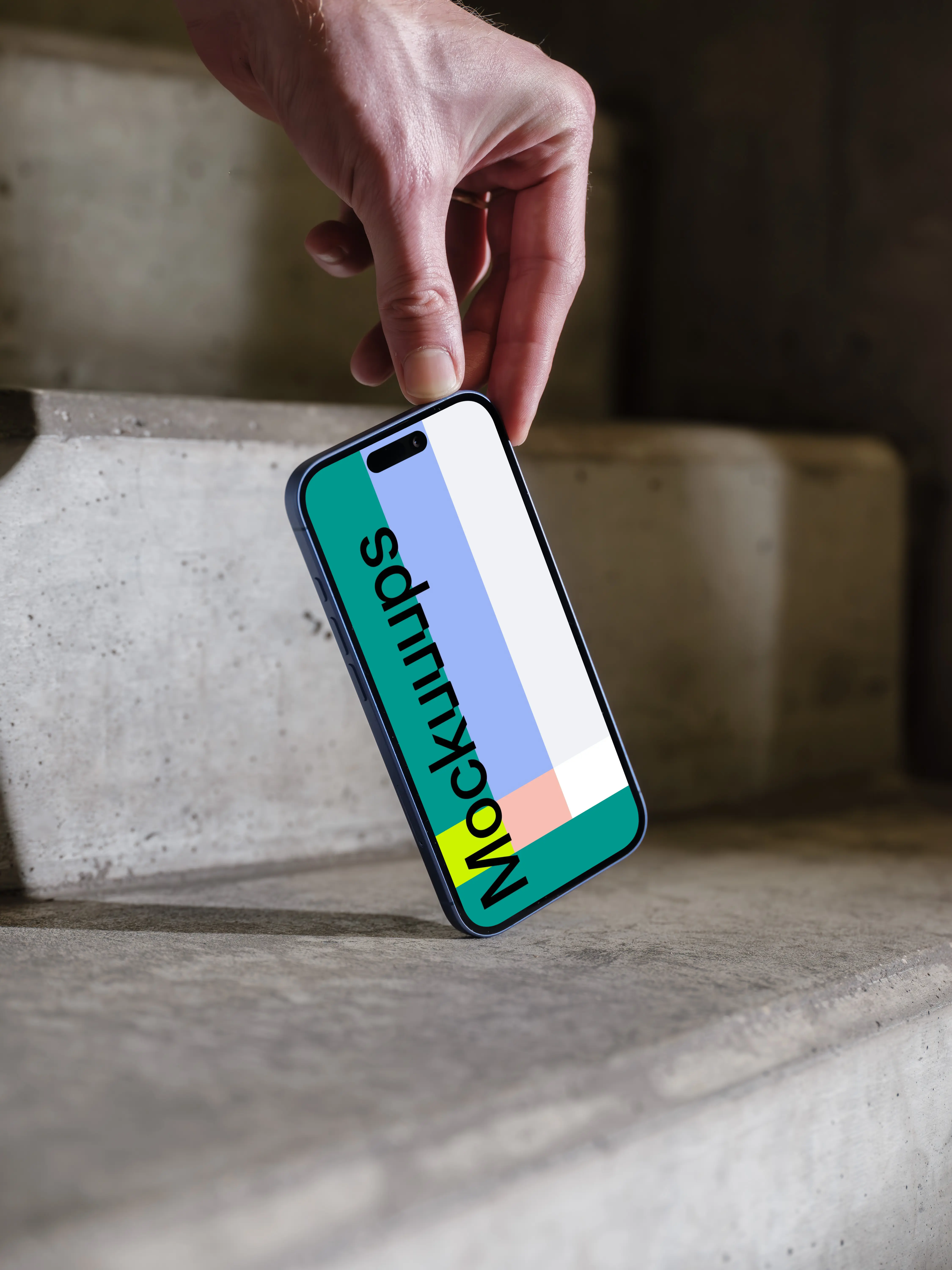 iPhone 16 mockup held on concrete stairs