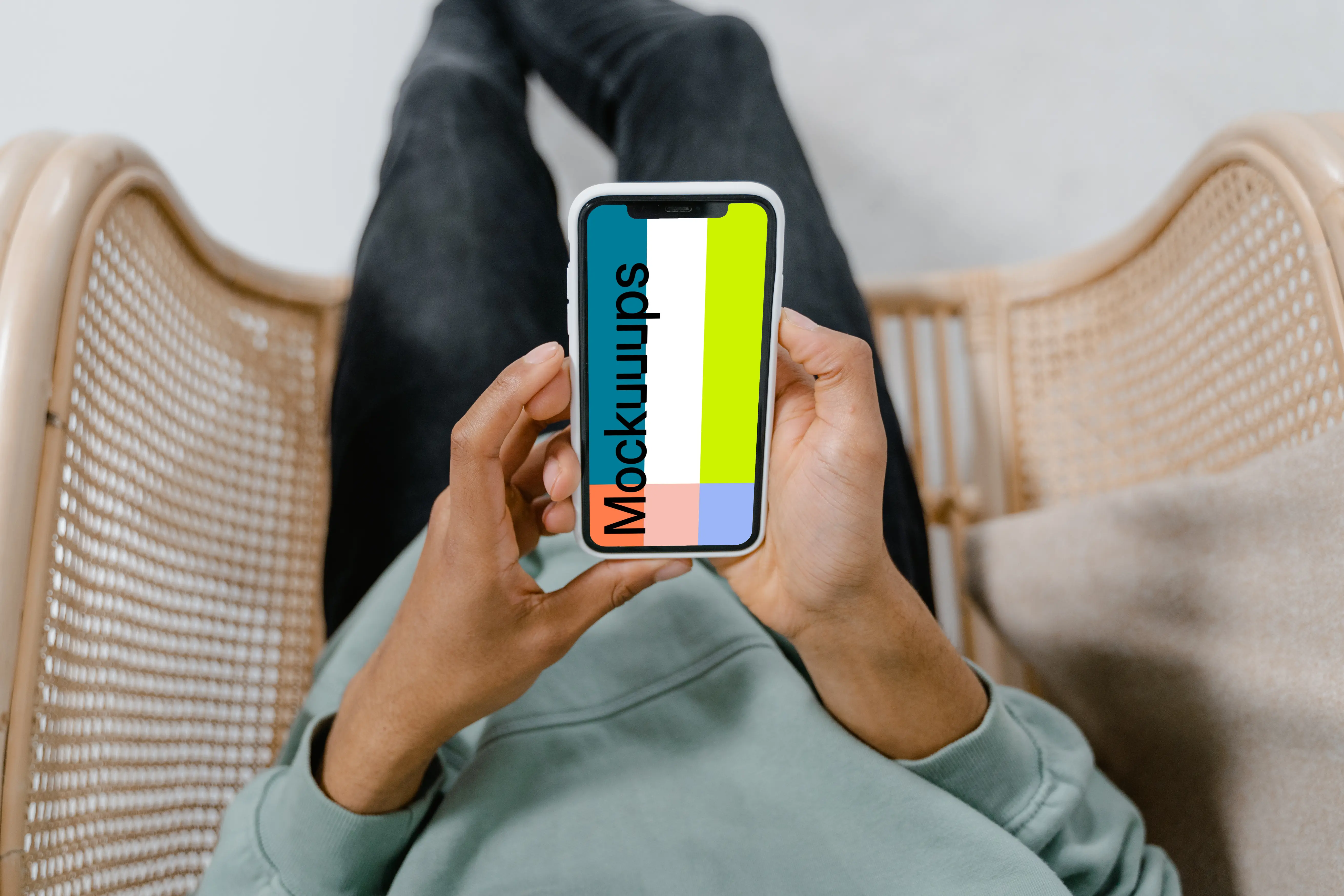 iPhone mockup held by user in a chair 